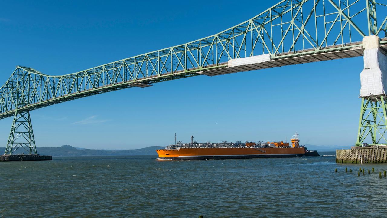 Refrigerated Liquefied Ammonia Barge at sea under a bridge