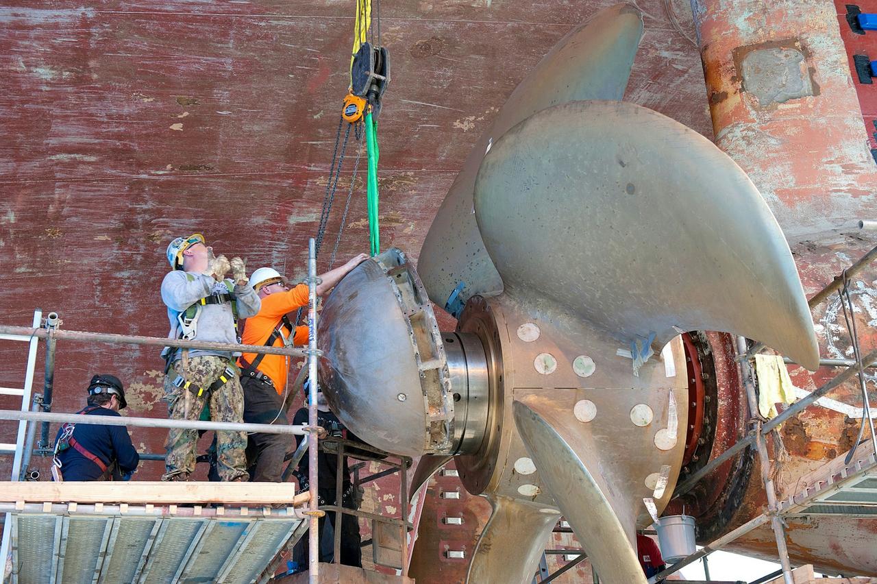 Workers installing a huge propeller