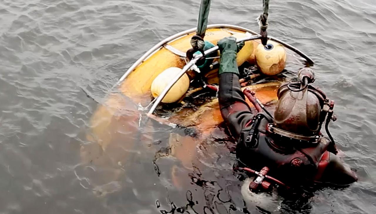 Diver with hull cleaning equipment