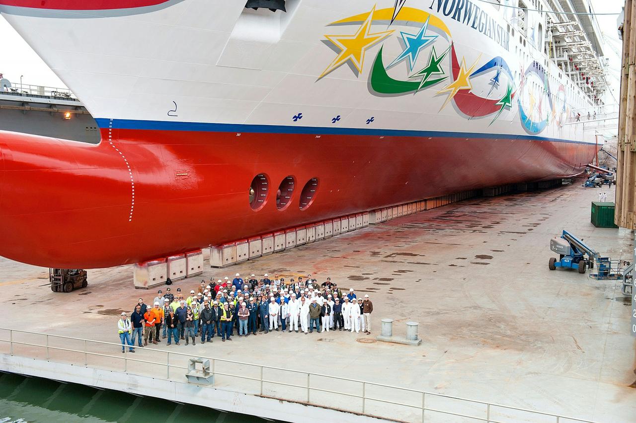 Vigor crew posing in front of the massive Norwegian Star