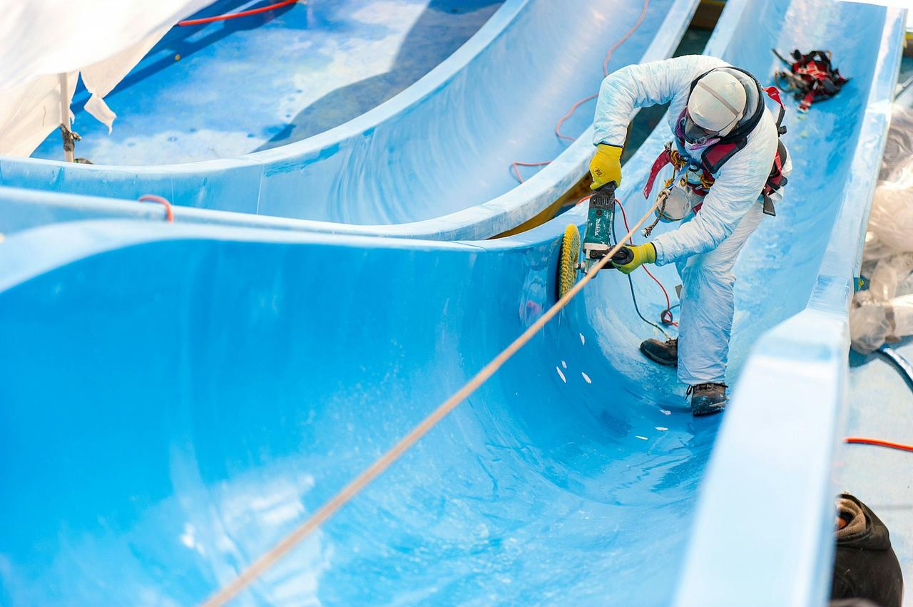 Worker polishing a slide on the Carnival Inspiration