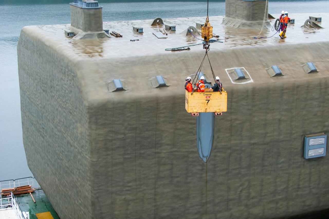Workers being lifted with a crane