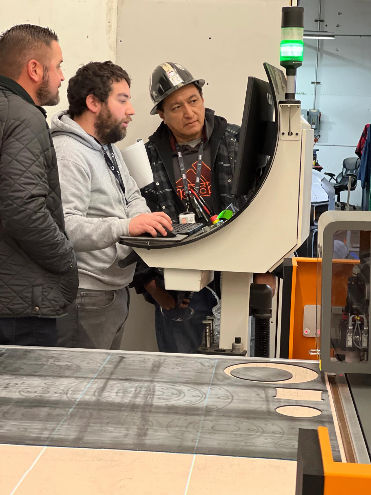 Workers in facility working on a machine