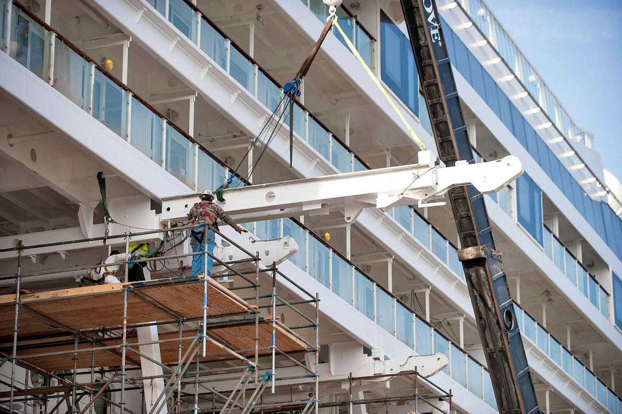 Workers with a crane and steel beams