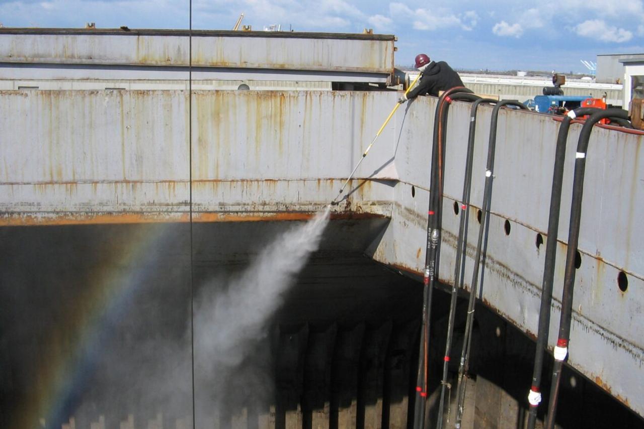 Accurate Worker cleaning a ship