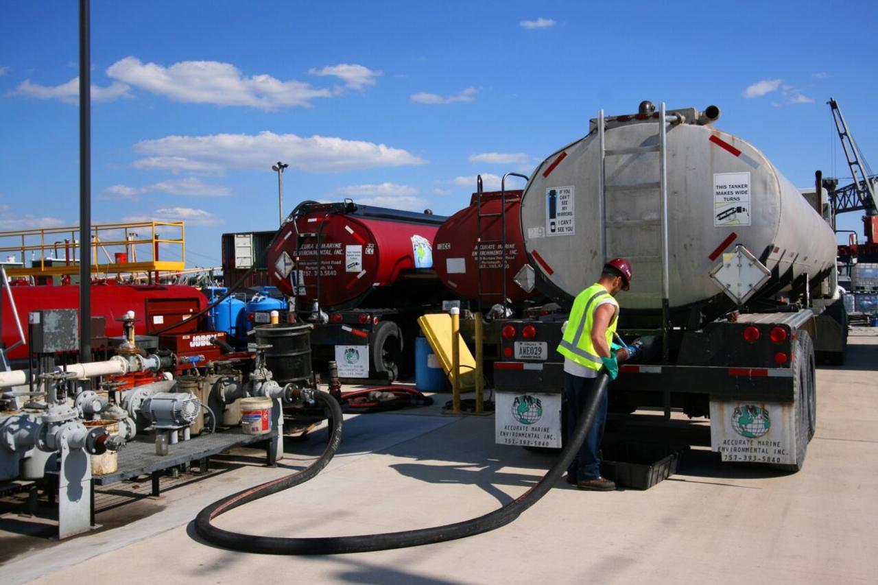 worker filling up a tanker truck