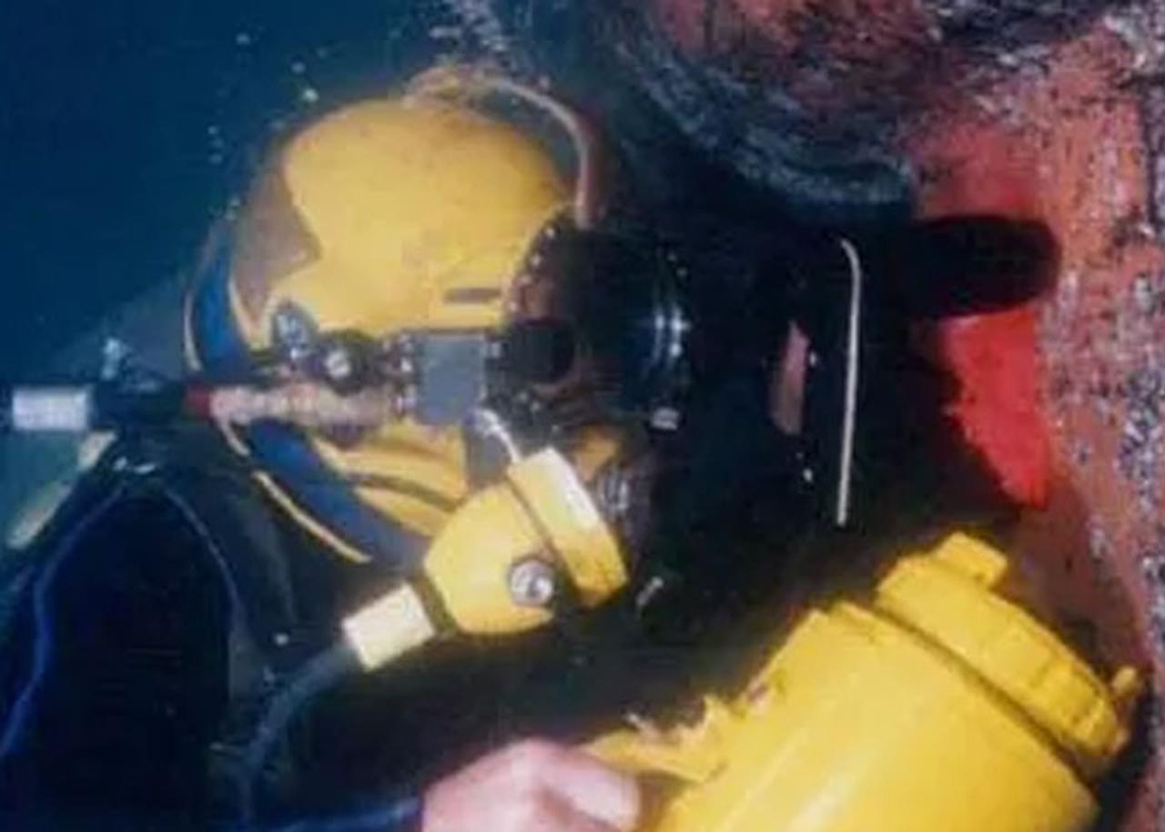 Diver doing crack detection on a ship
