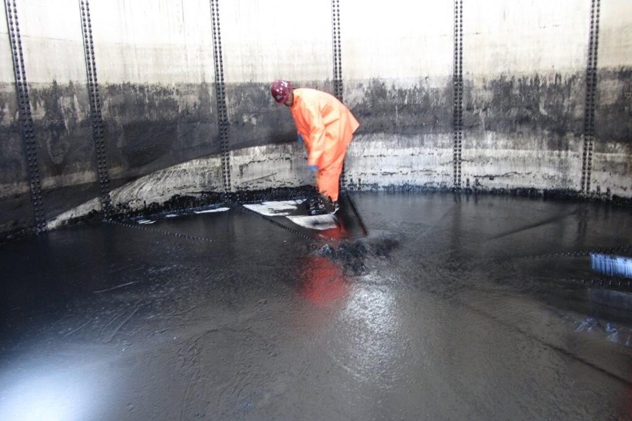 Accurate worker cleaning a tank