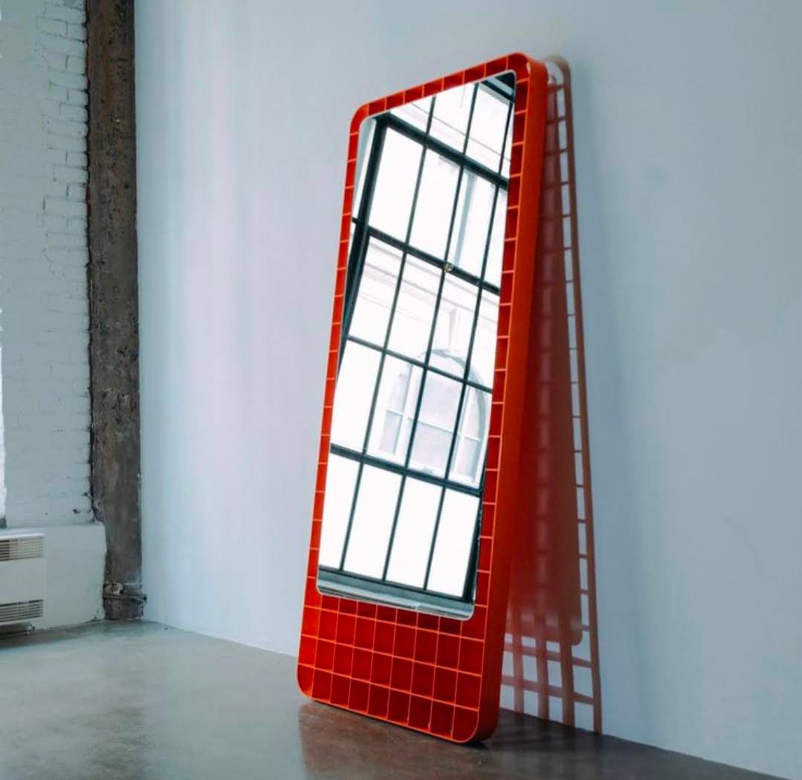 Full-length mirror in a grid steel frame