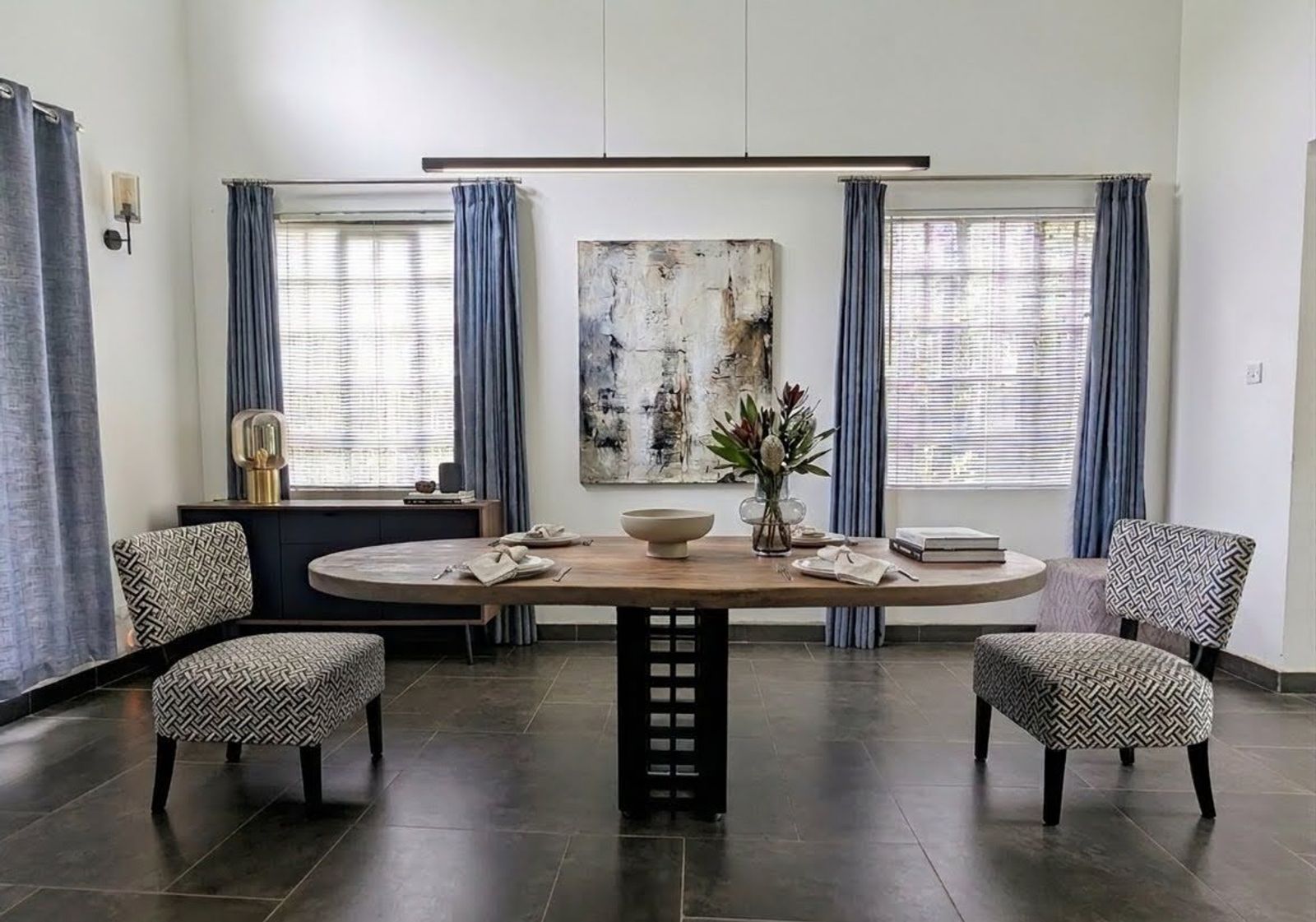 Single Pedestal Cube Metal Base with Oval Table Top in Walnut Finish offering seating for Six