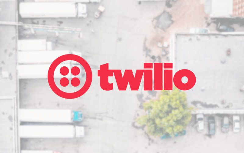 Arial view of loading docks controlled by Mobiledock, overlayed with a logo of Twilio.