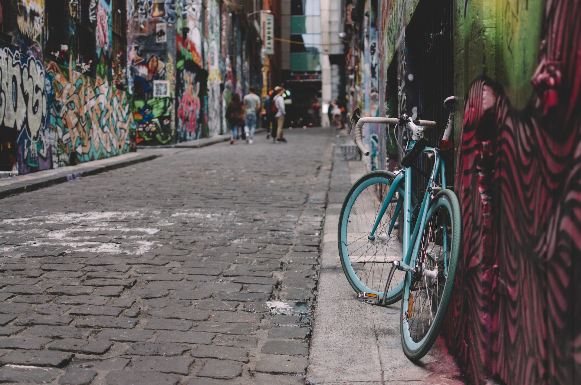 A bike leaning against a graffitied wall