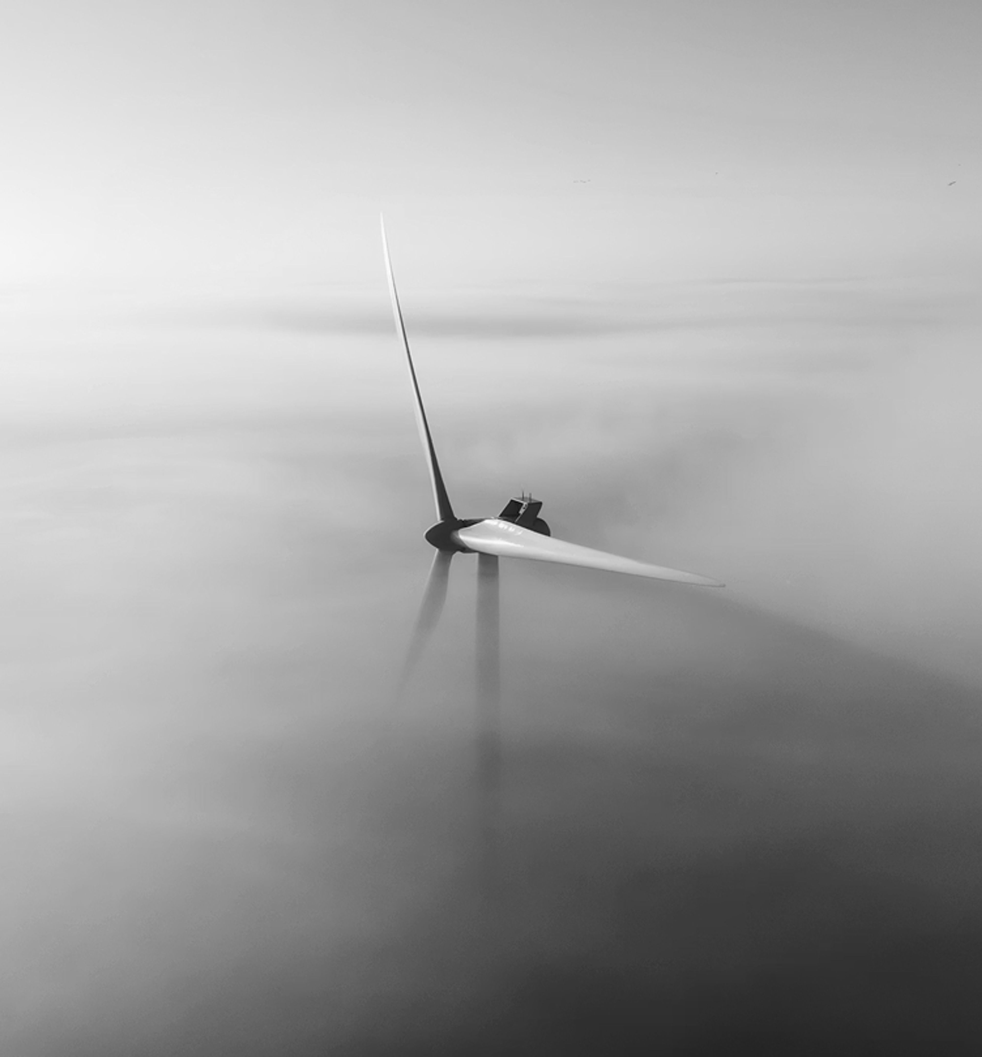 Windmill poking through clouds