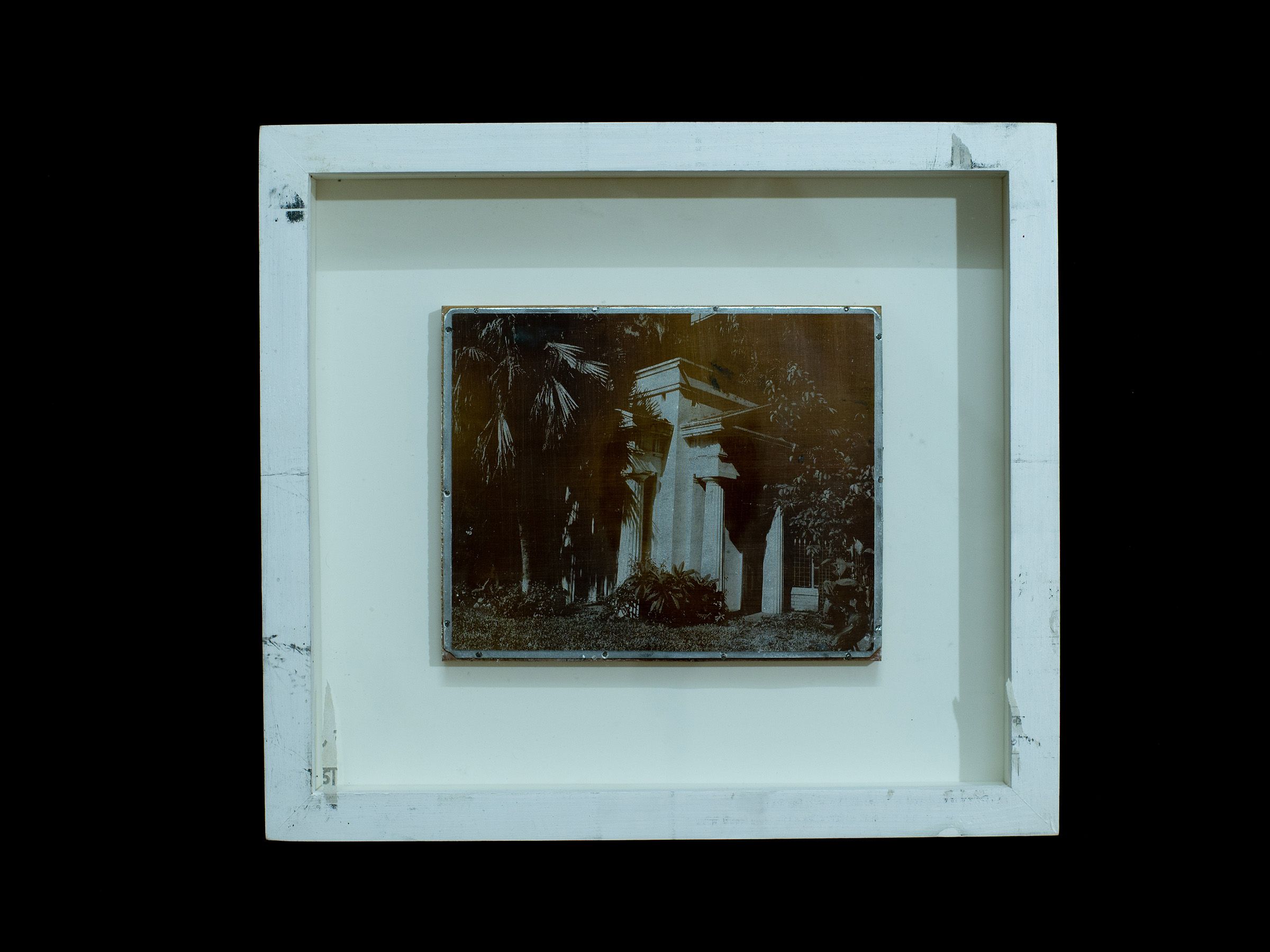 Small zinc plate depicting a columned structure among trees displayed in a white frame.