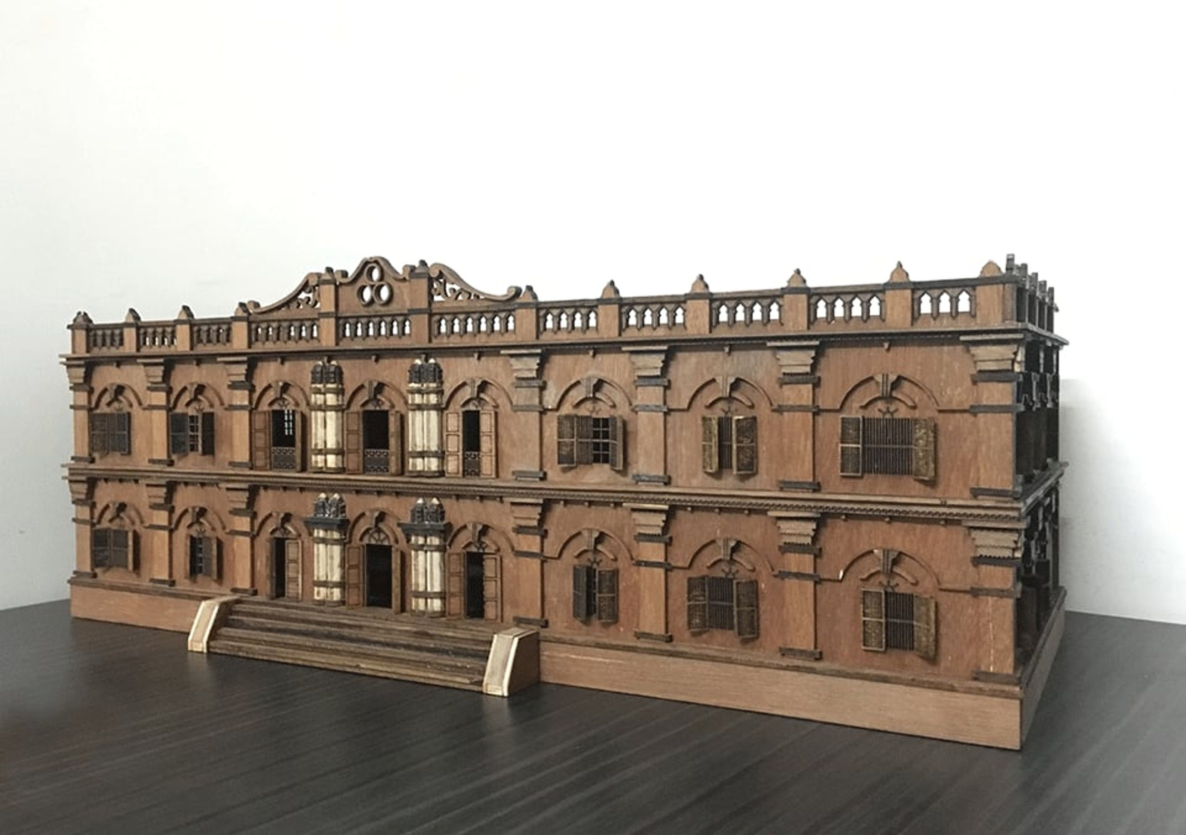 Sepia-toned view of a palace model submerged beneath rippling water.