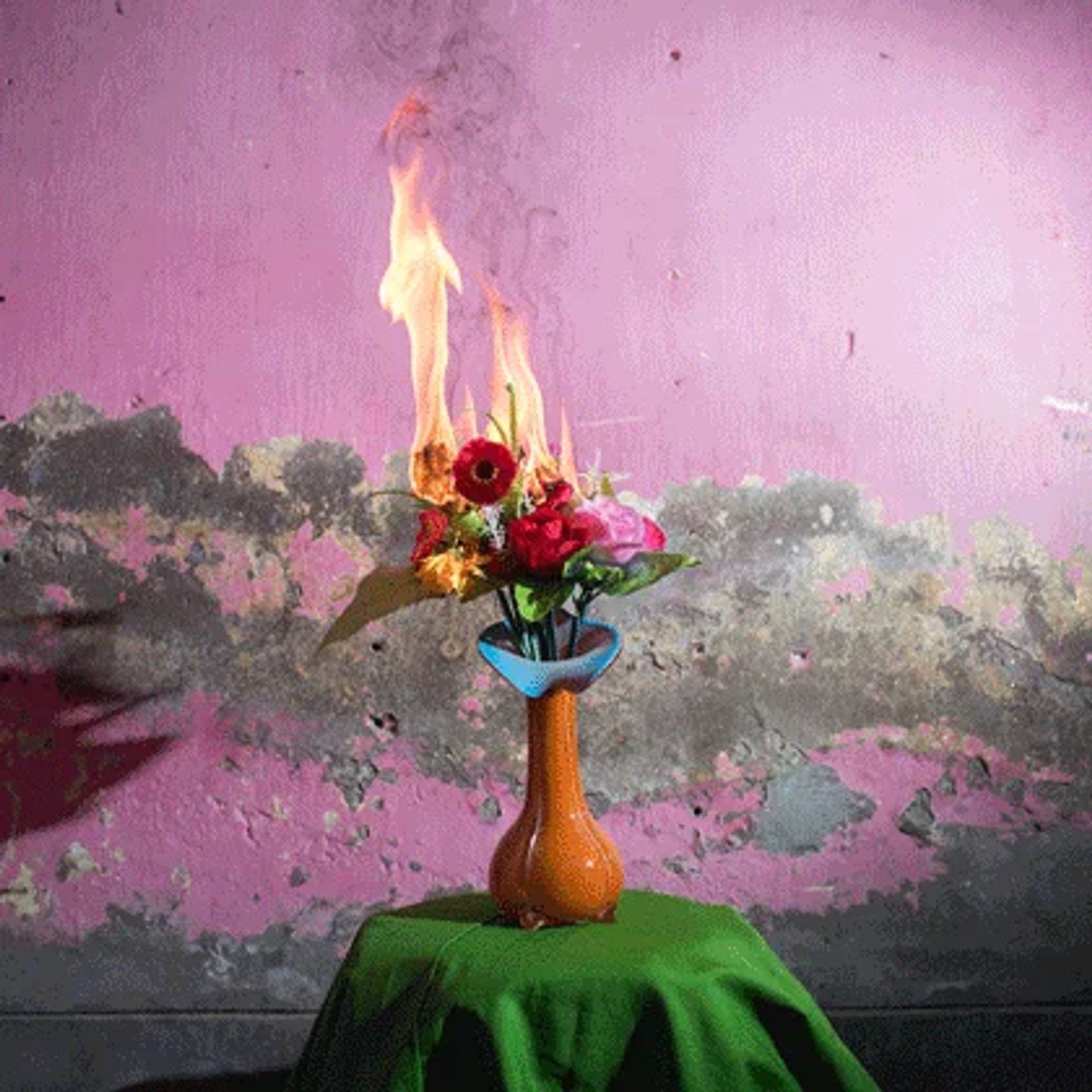 Animated flames rise from a bouquet of red and pink flowers in an orange vase.