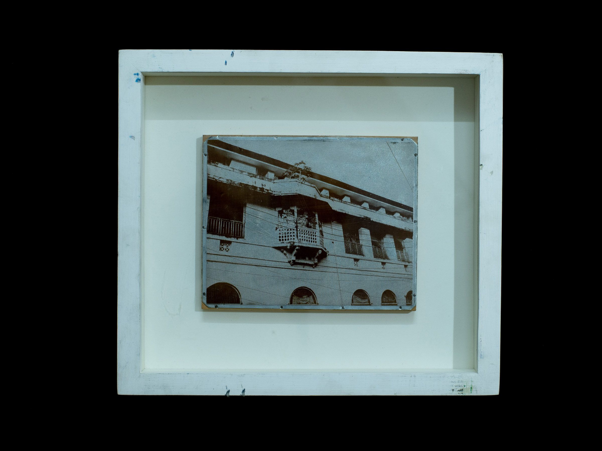 Small zinc plate depicting a weathered two-story colonial building displayed in a white frame.