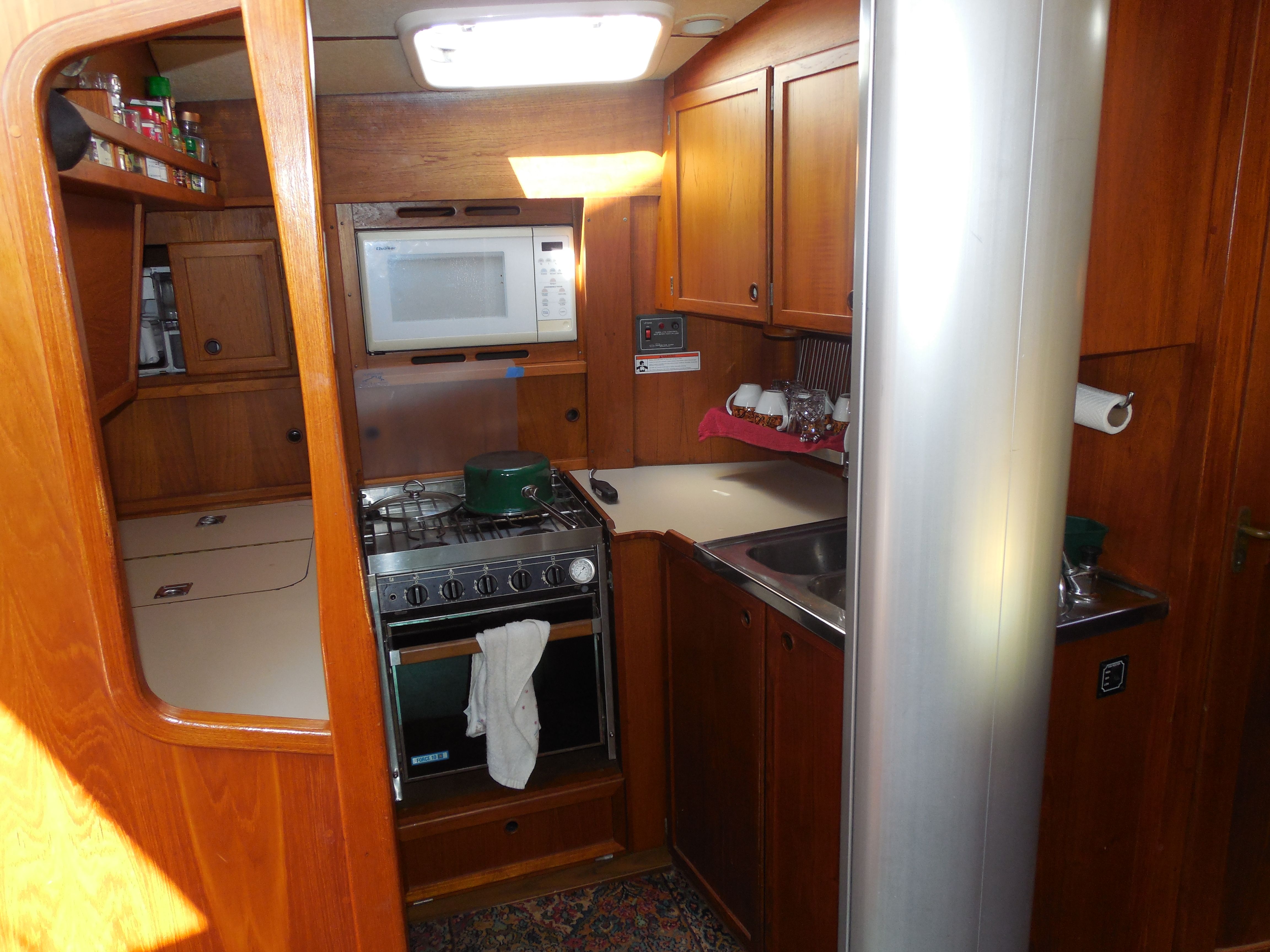 Well-equipped galley with warm wood cabinetry