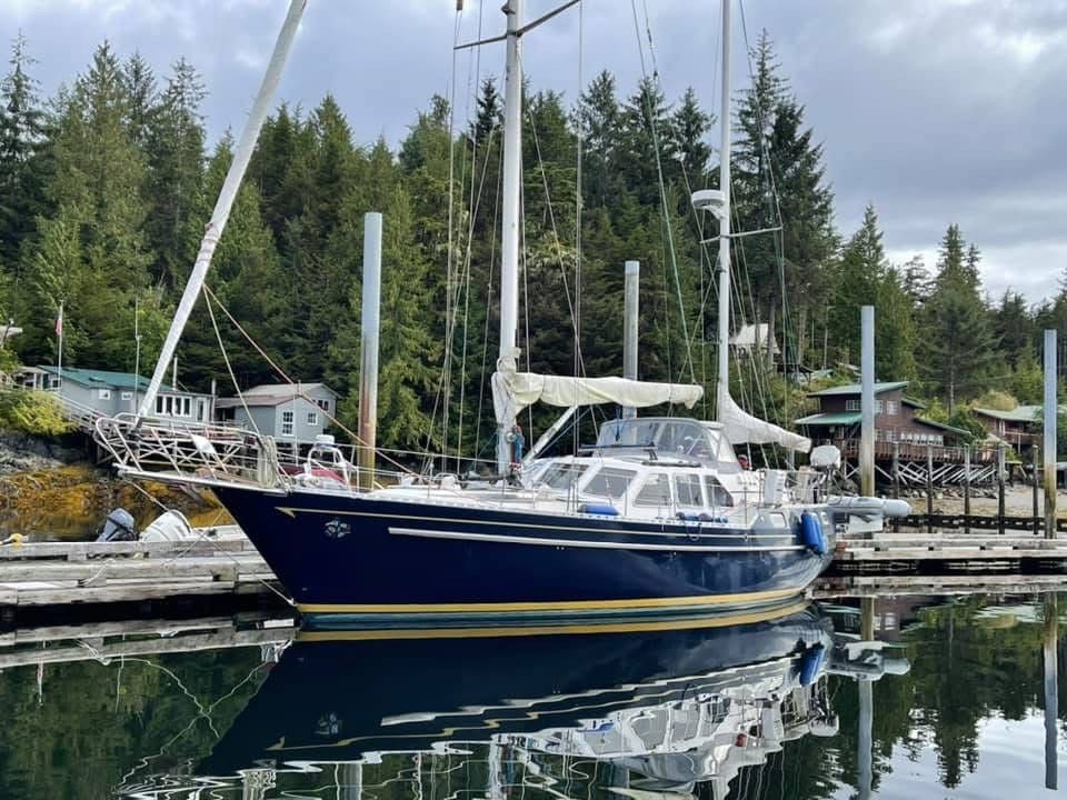 Front view of Raven's Dance showing the beautiful blue hull and ketch rig