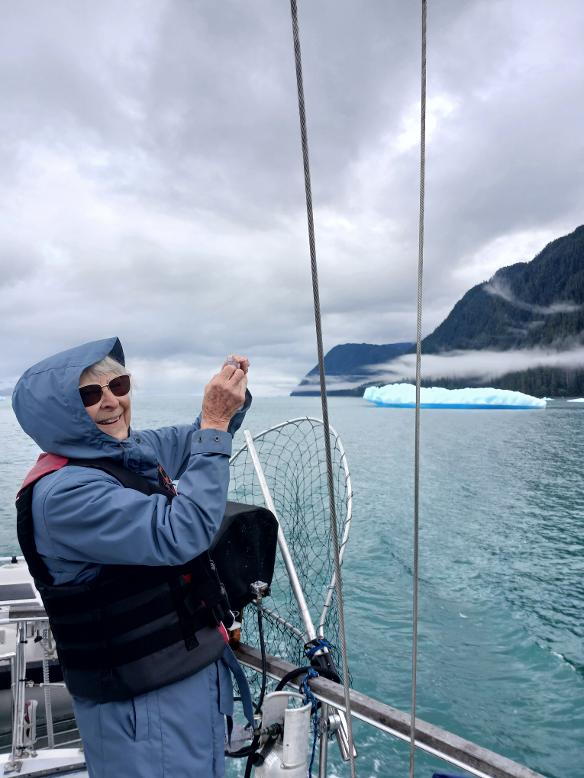 Smiling lady taking pictures of icebergs