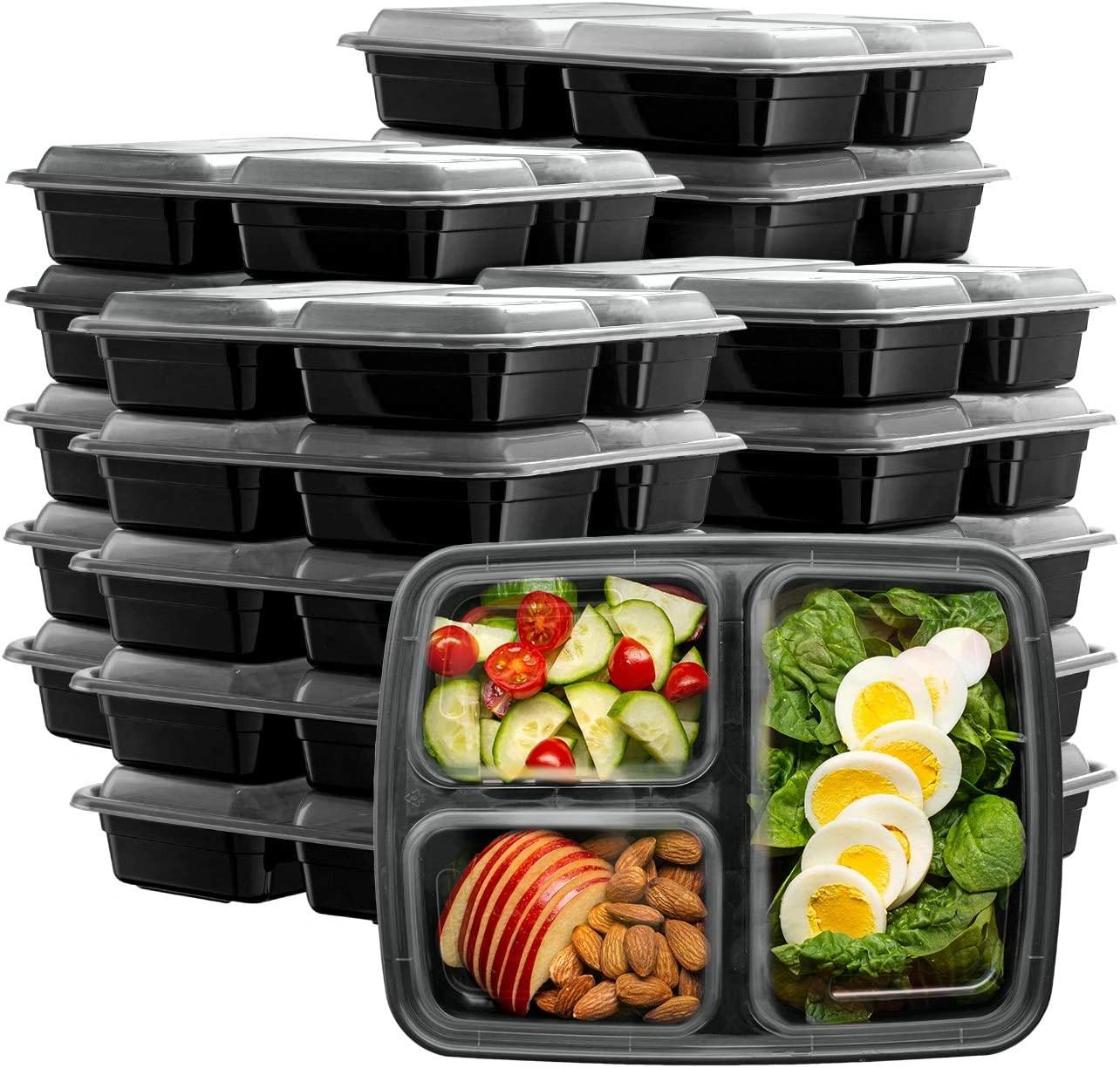 Meal prep containers filled with grilled chicken breast, roasted broccoli, carrots, bell peppers, red onions, leafy greens, and mixed nuts arranged neatly on a wooden table. Top-down view with natural lighting and a healthy eating concept.