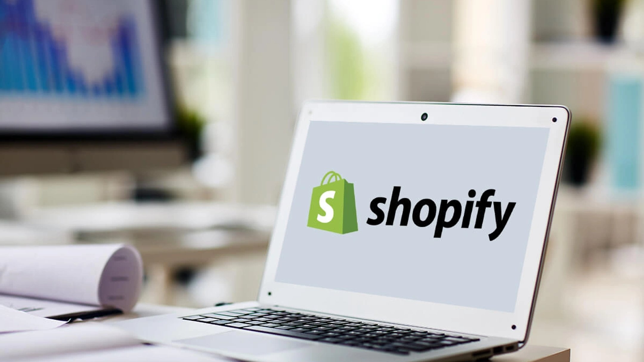 A laptop showing the Shopify logo