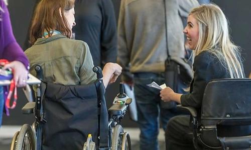 Two reporters using wheelchairs at a press conference