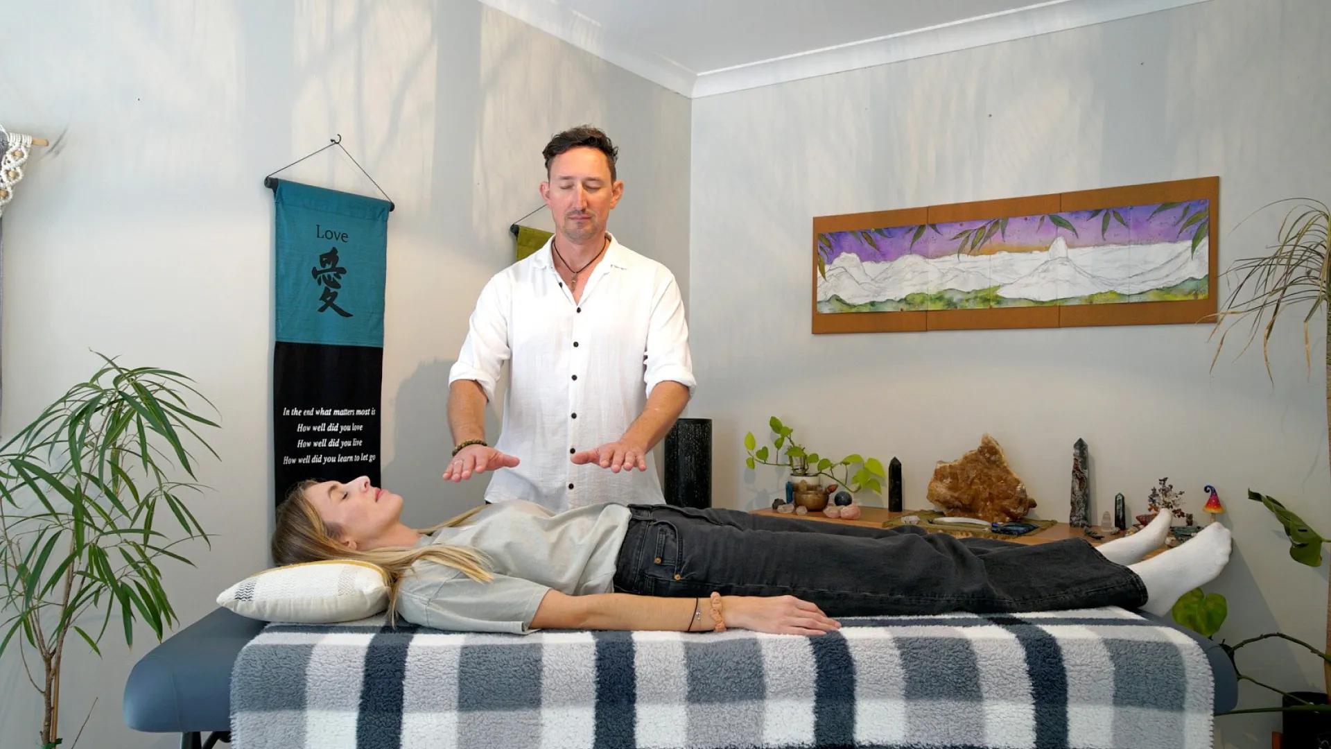 A photo of David performing Reiki.