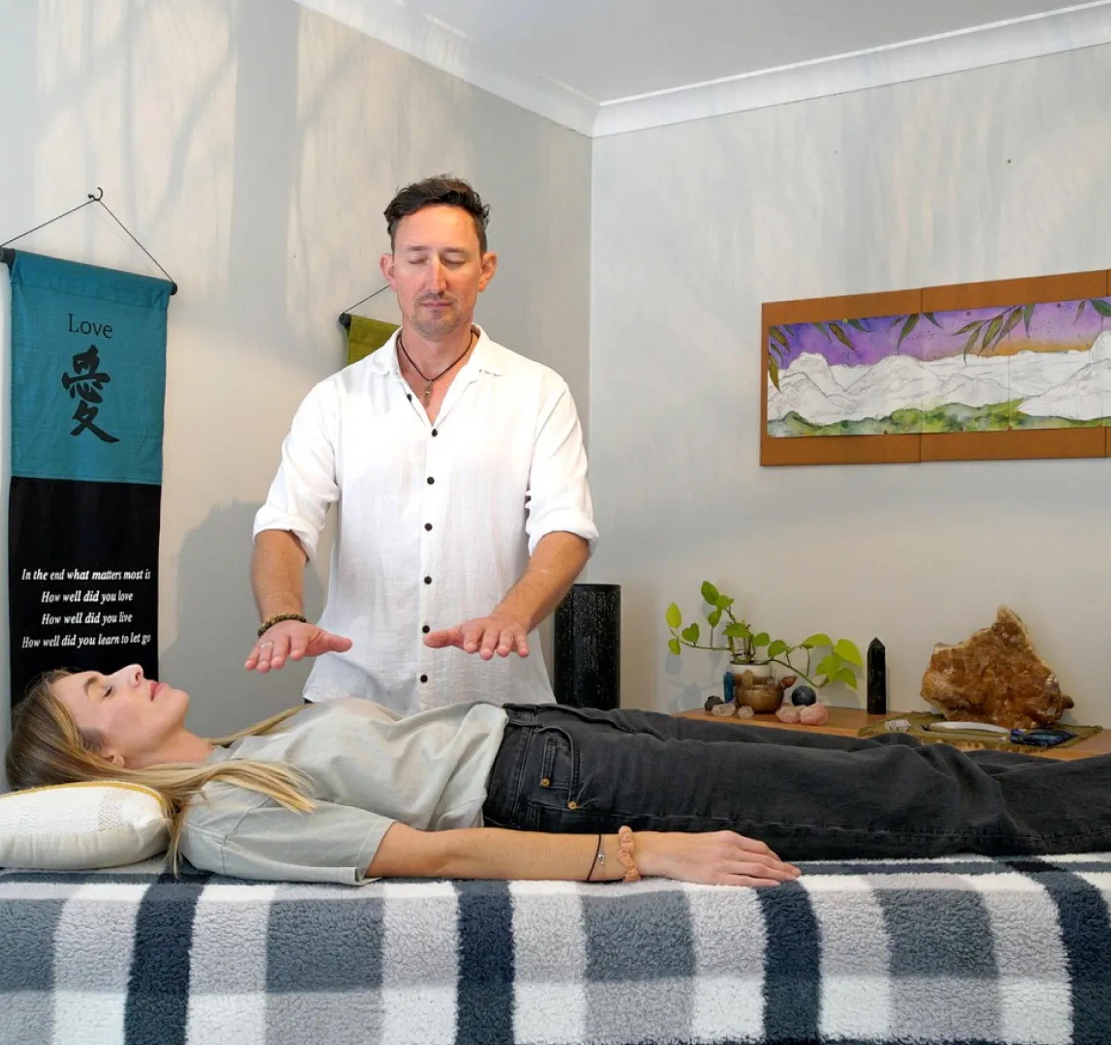 A photo of David performing Reiki.