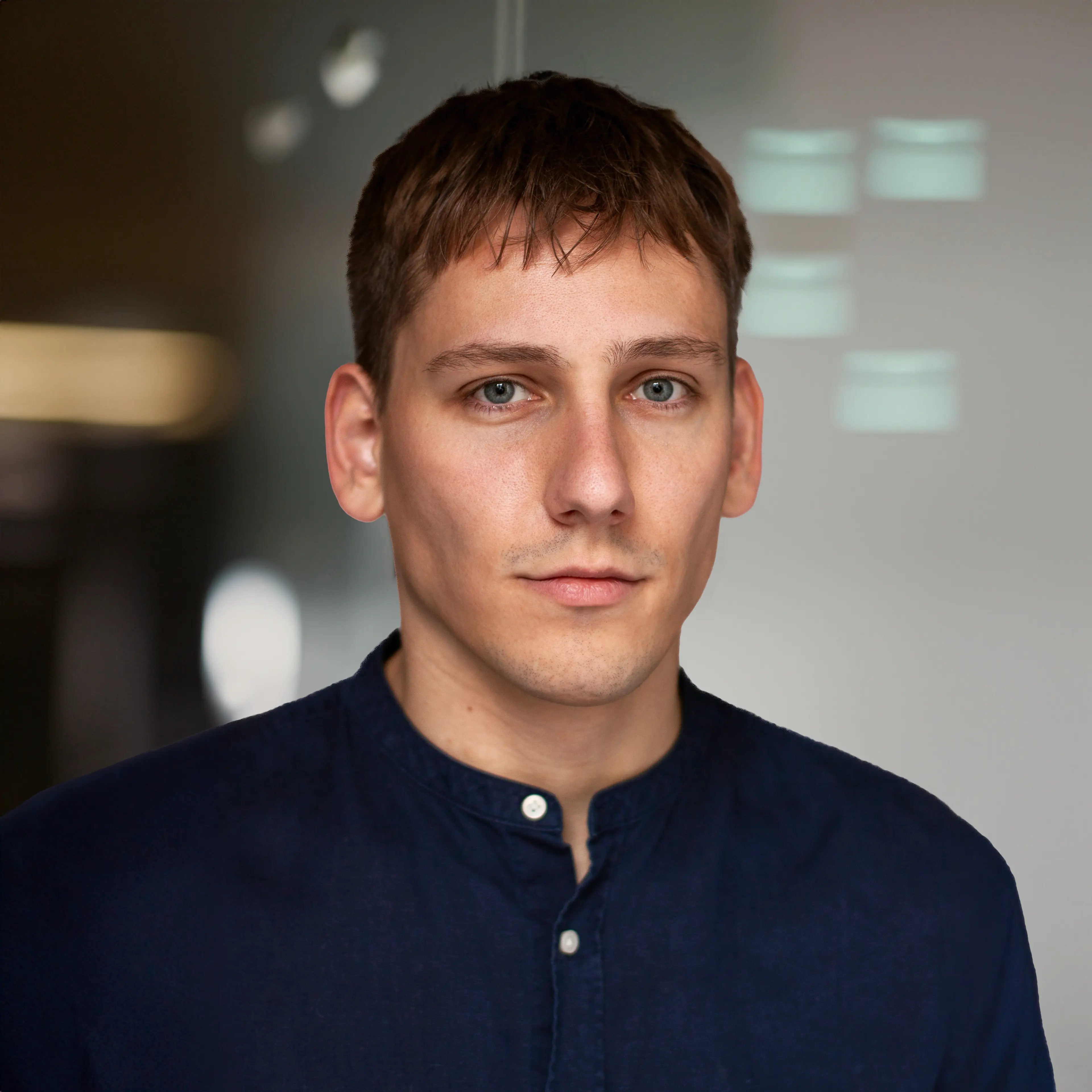 Man wearing a blue shirt with white buttons