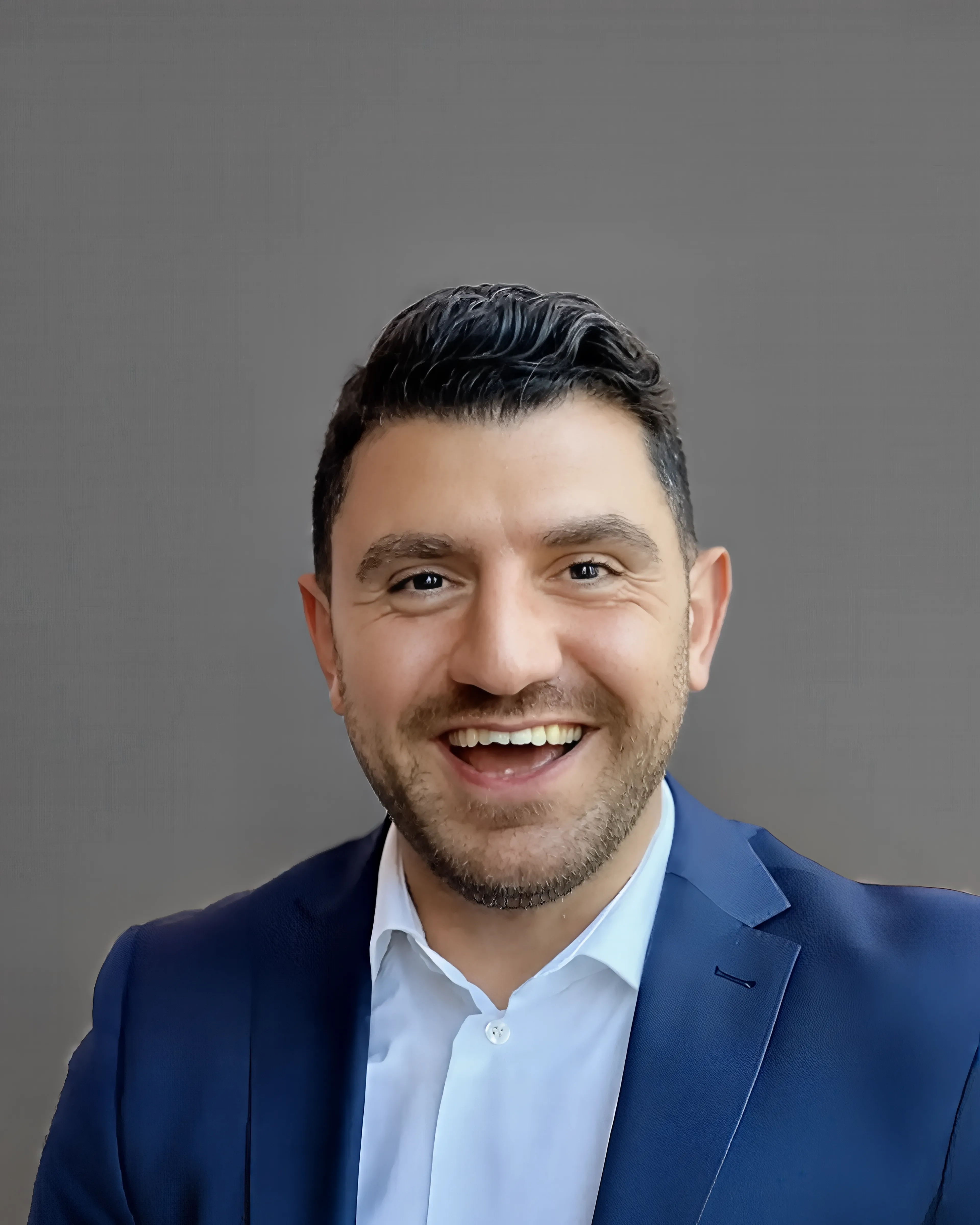 a smiling man wearing a blue suit