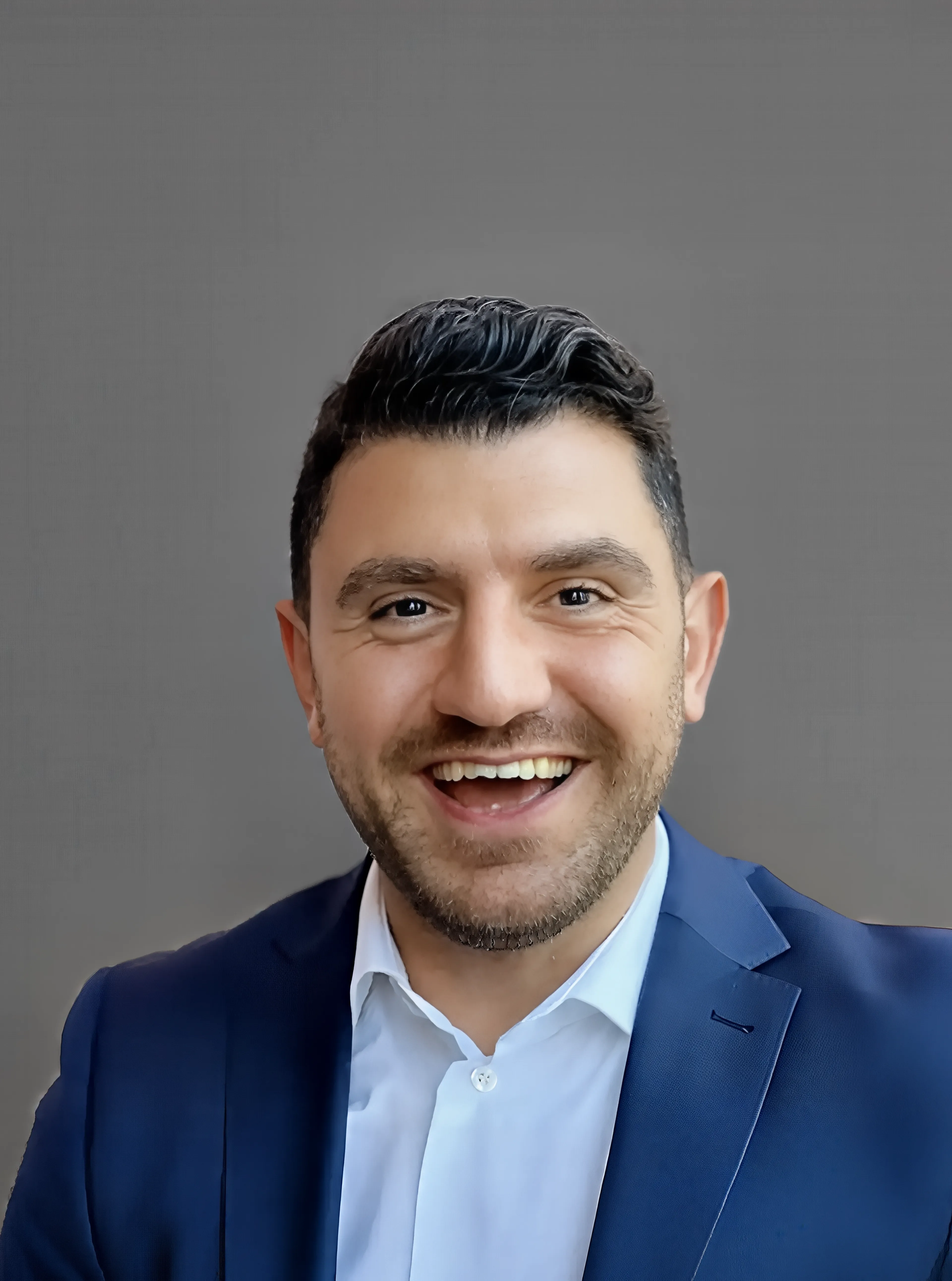 Bashar Shaya, a smiling man wearing a blue suit