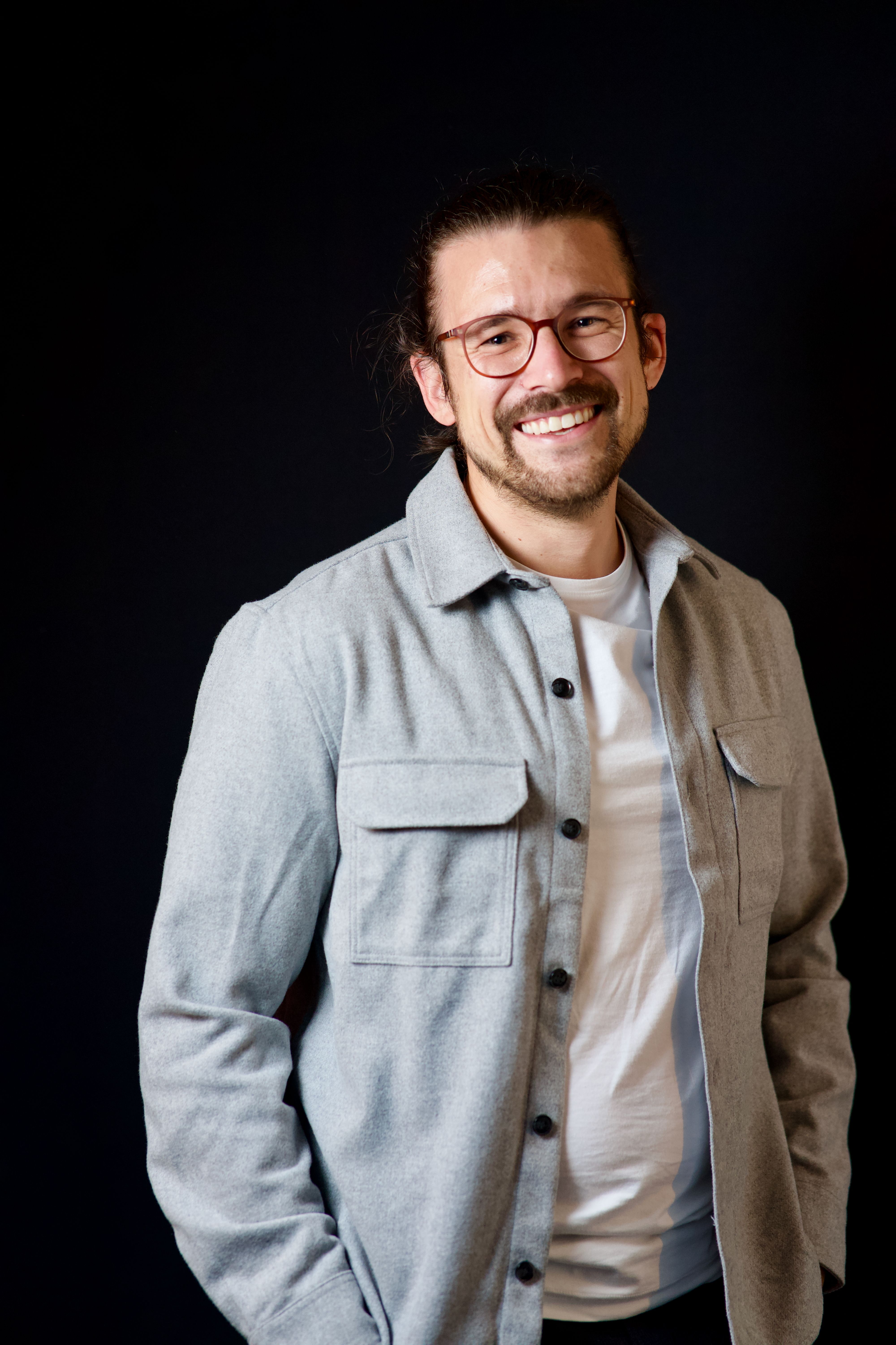 Smiling man with glasses.