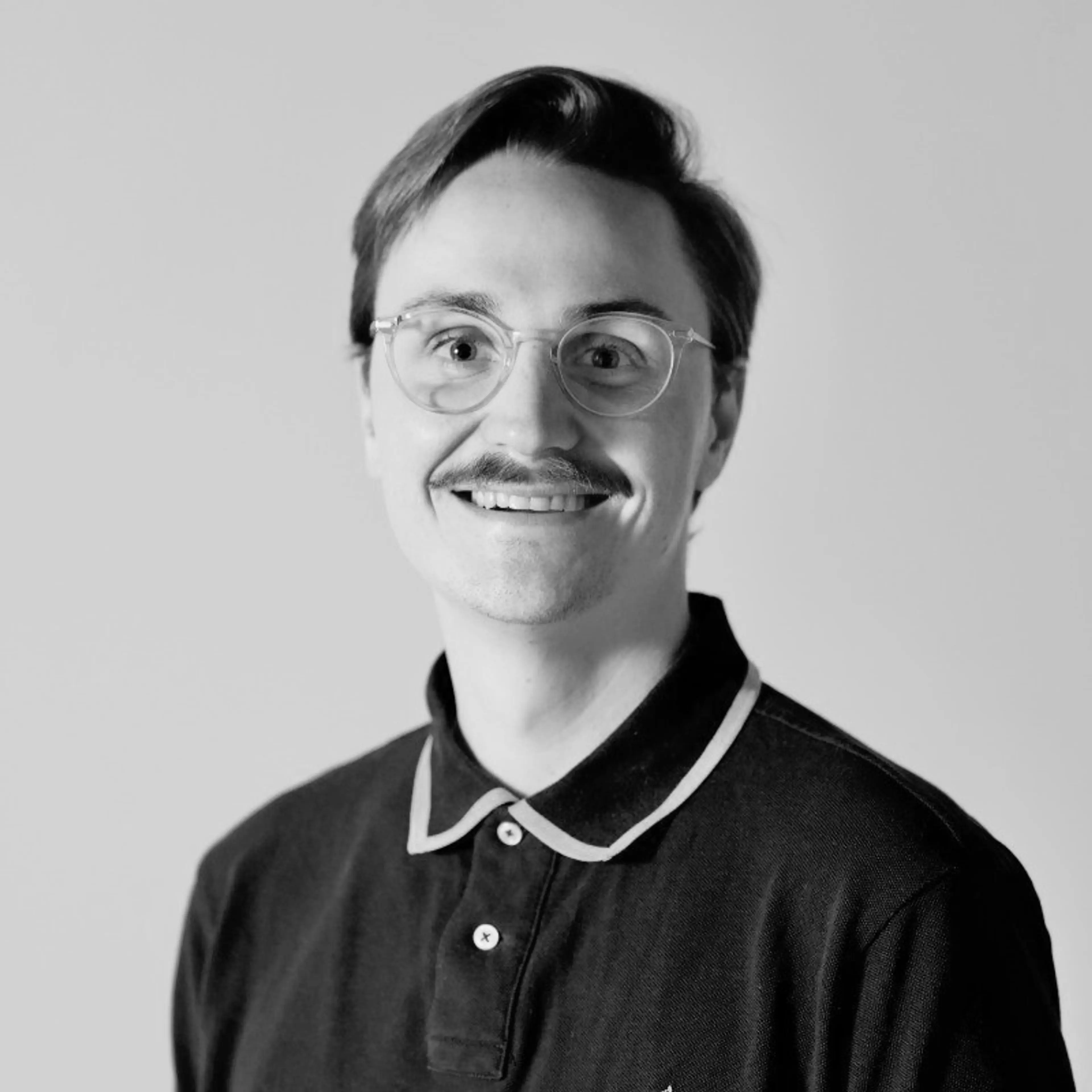 Black and white image of a man with glasses.