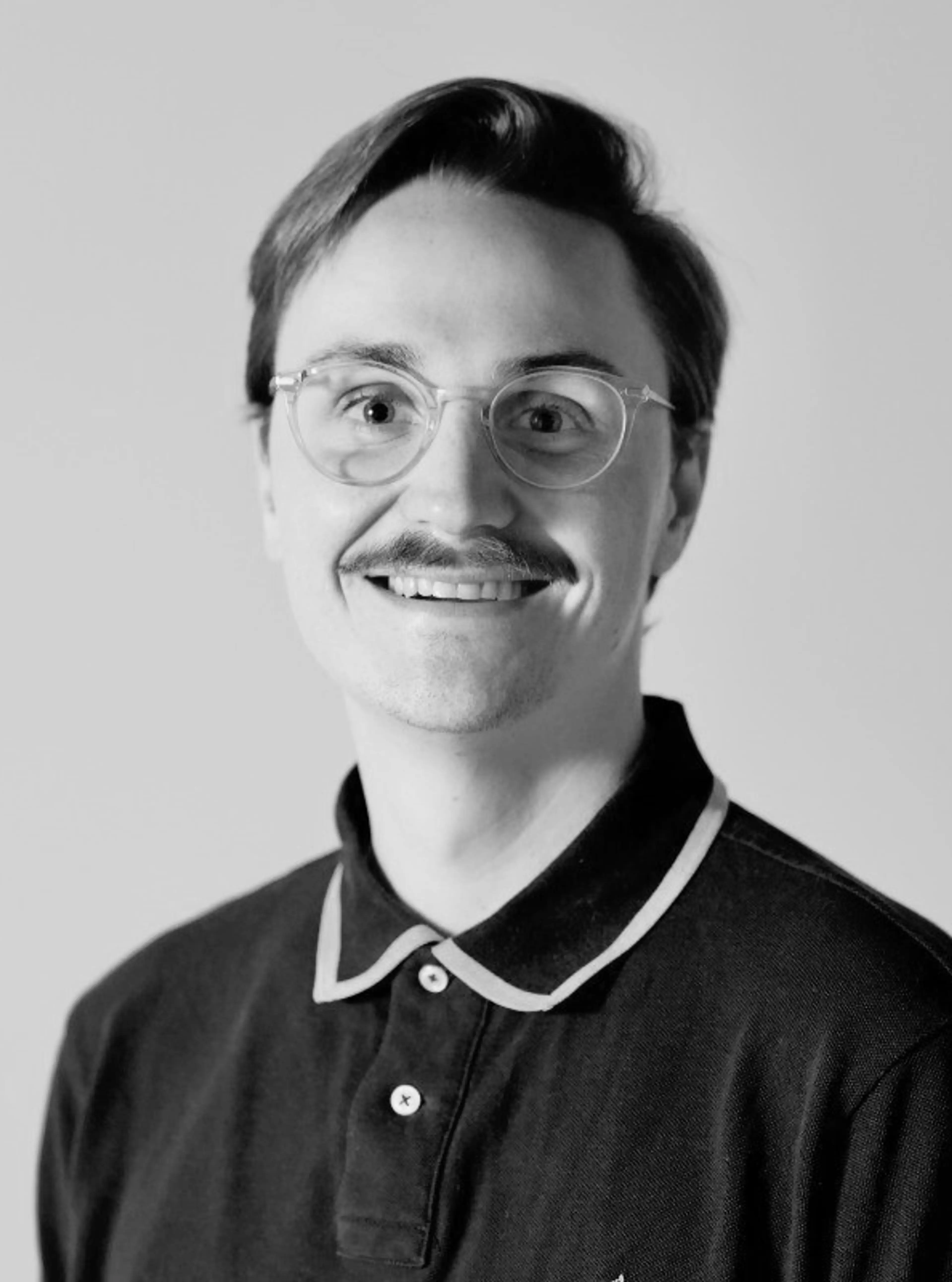Black and white image of a man with glasses.