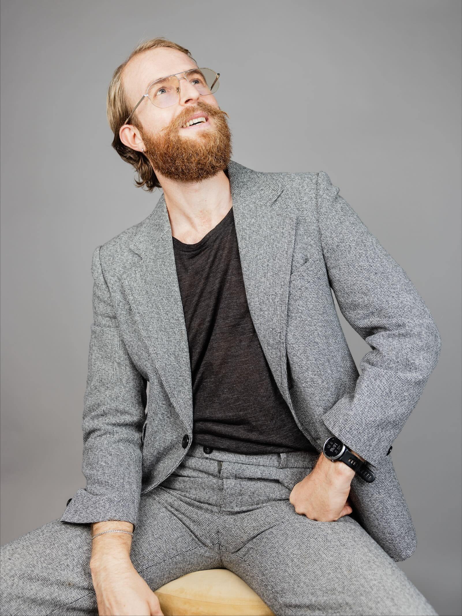 Man with glasses looking upwards