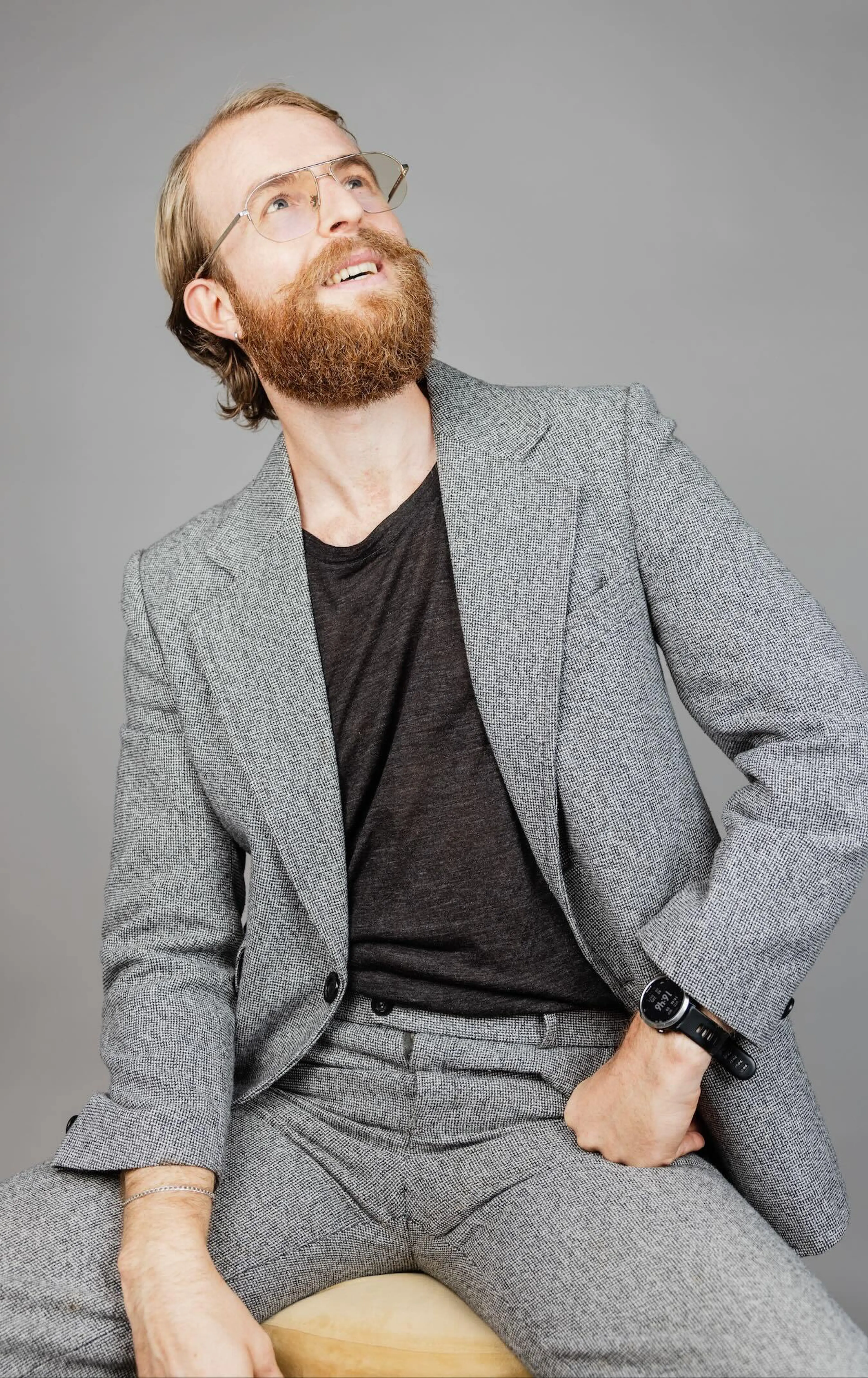 Man with glasses looking upwards