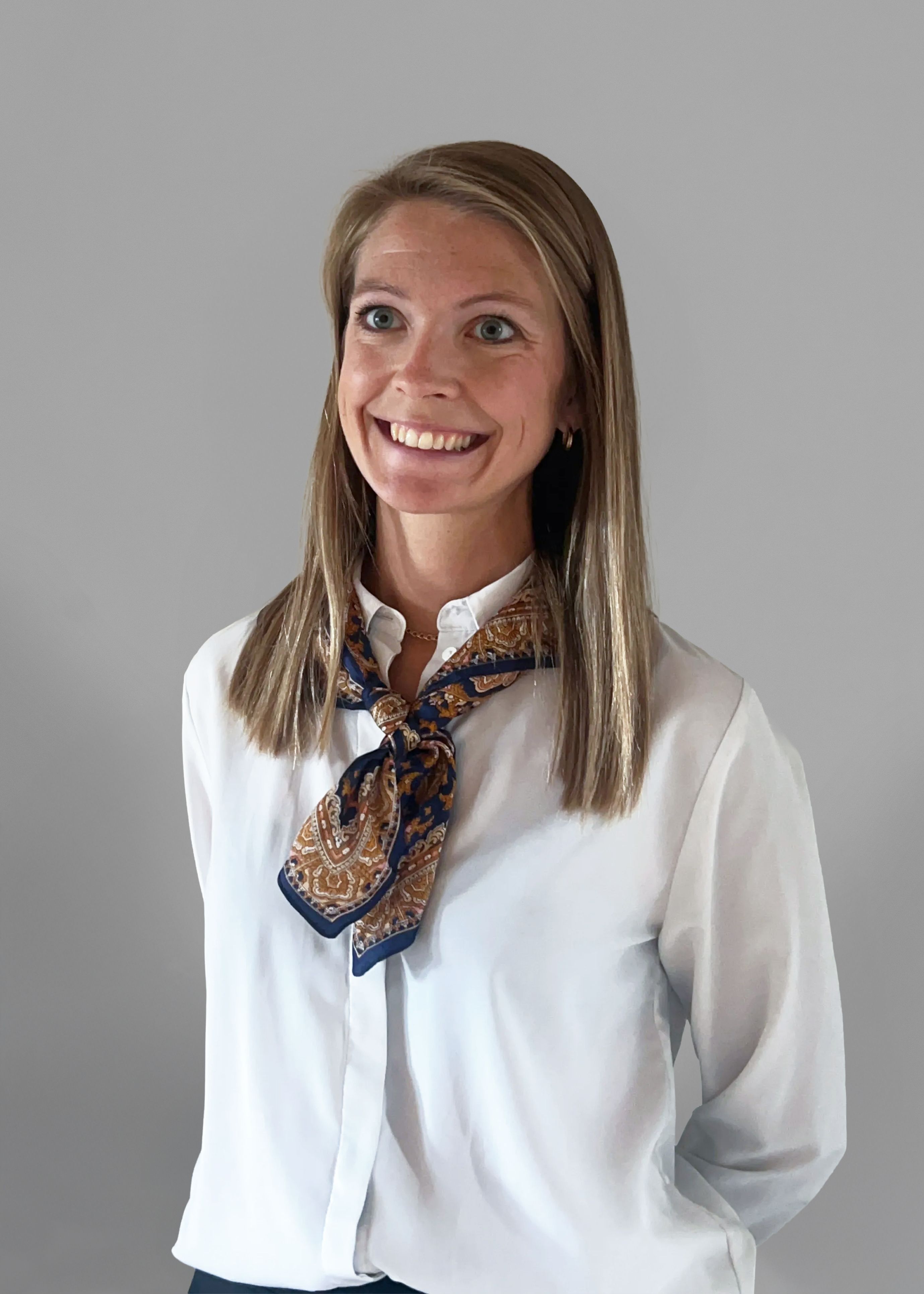 Smiling woman wearing a white shirt.