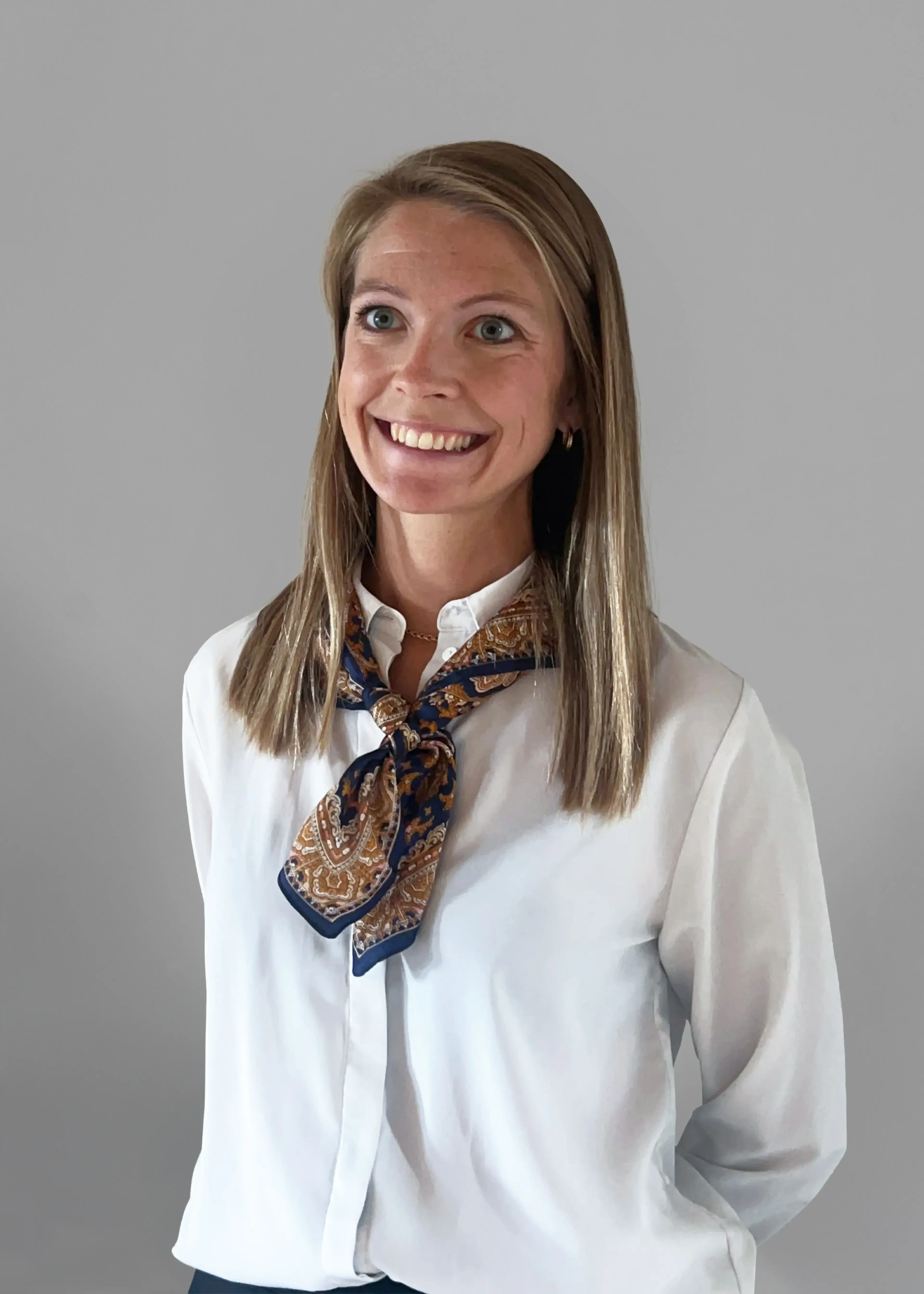 Smiling woman wearing a white shirt.