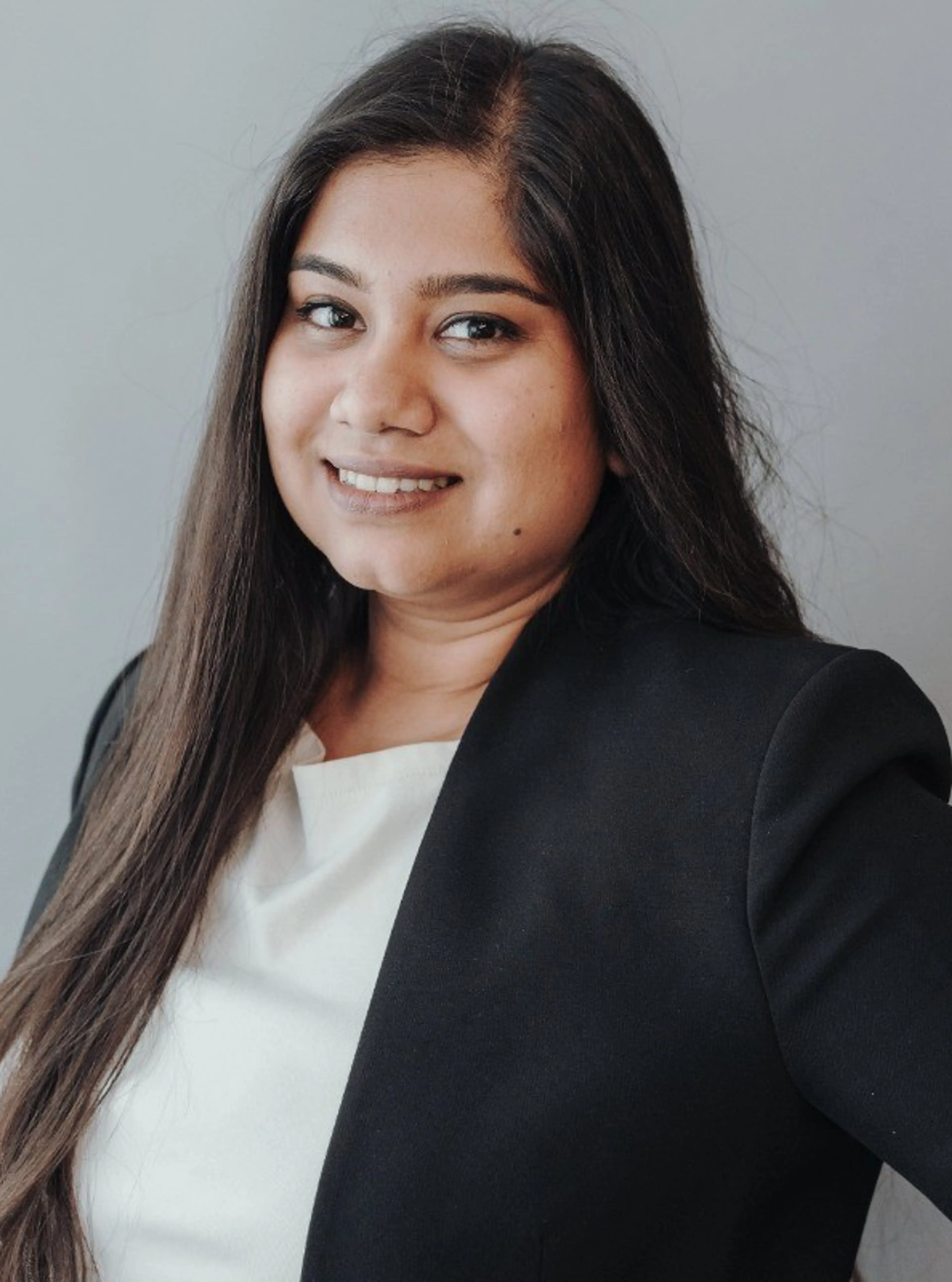 Image of female consultant wearing a black suit and white blouse