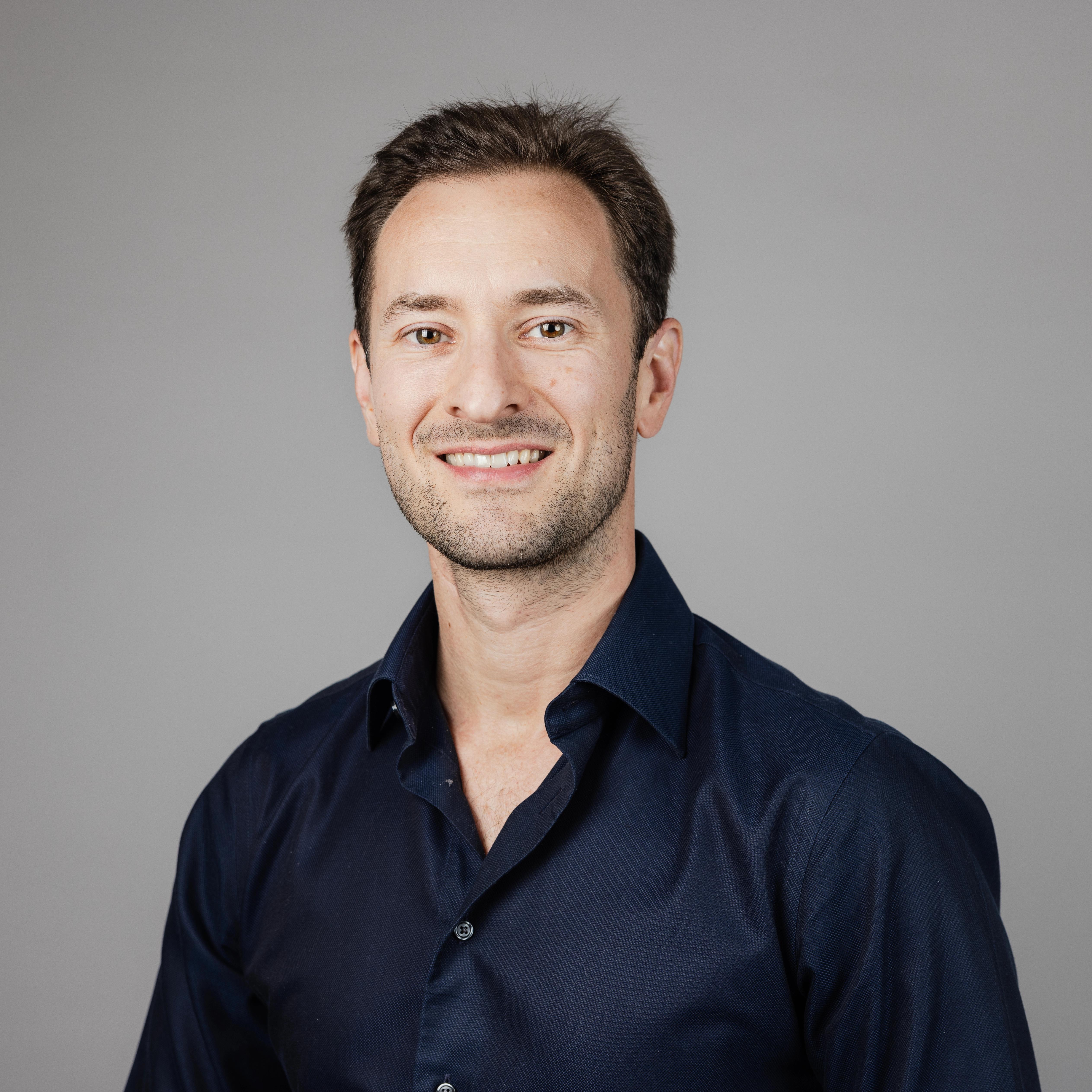 Smiling man with a blue shirt