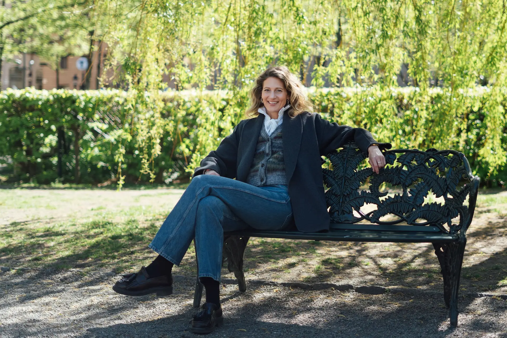 Woman sitting on a bench smilling