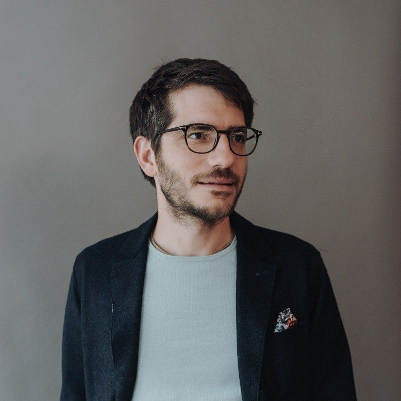 Smiling man with glasses.