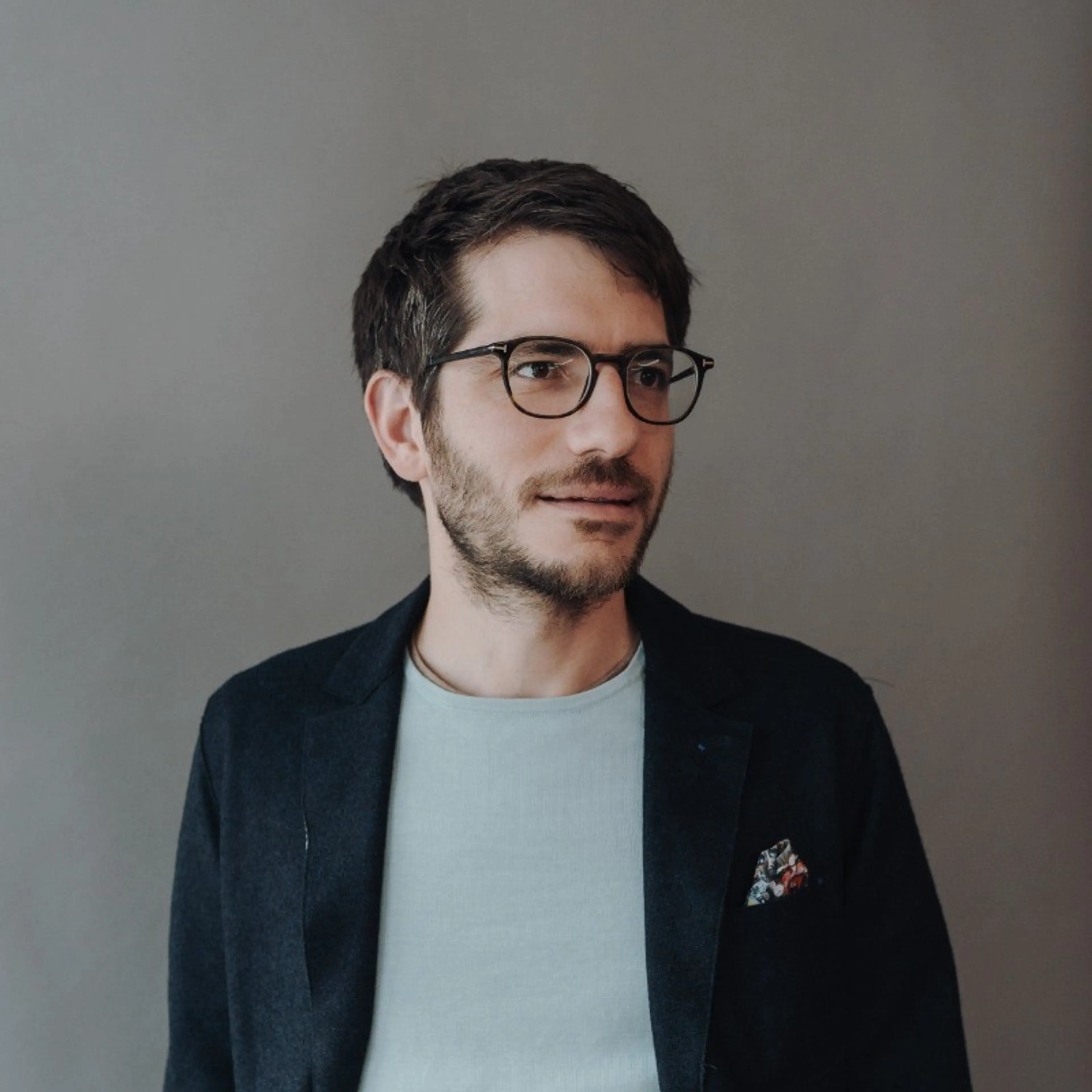 Smiling man with glasses.