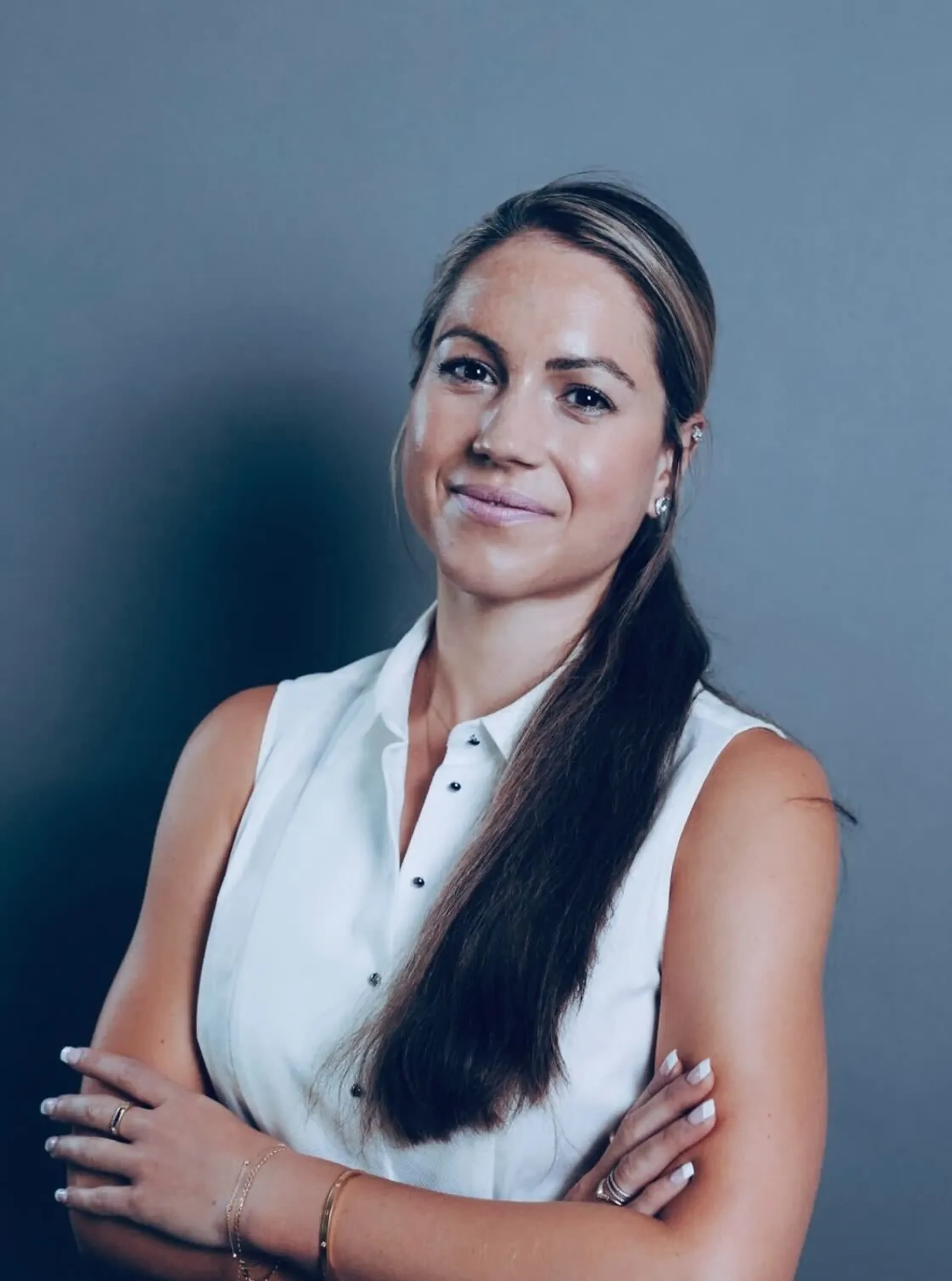 Smiling woman wearing a white shirt.