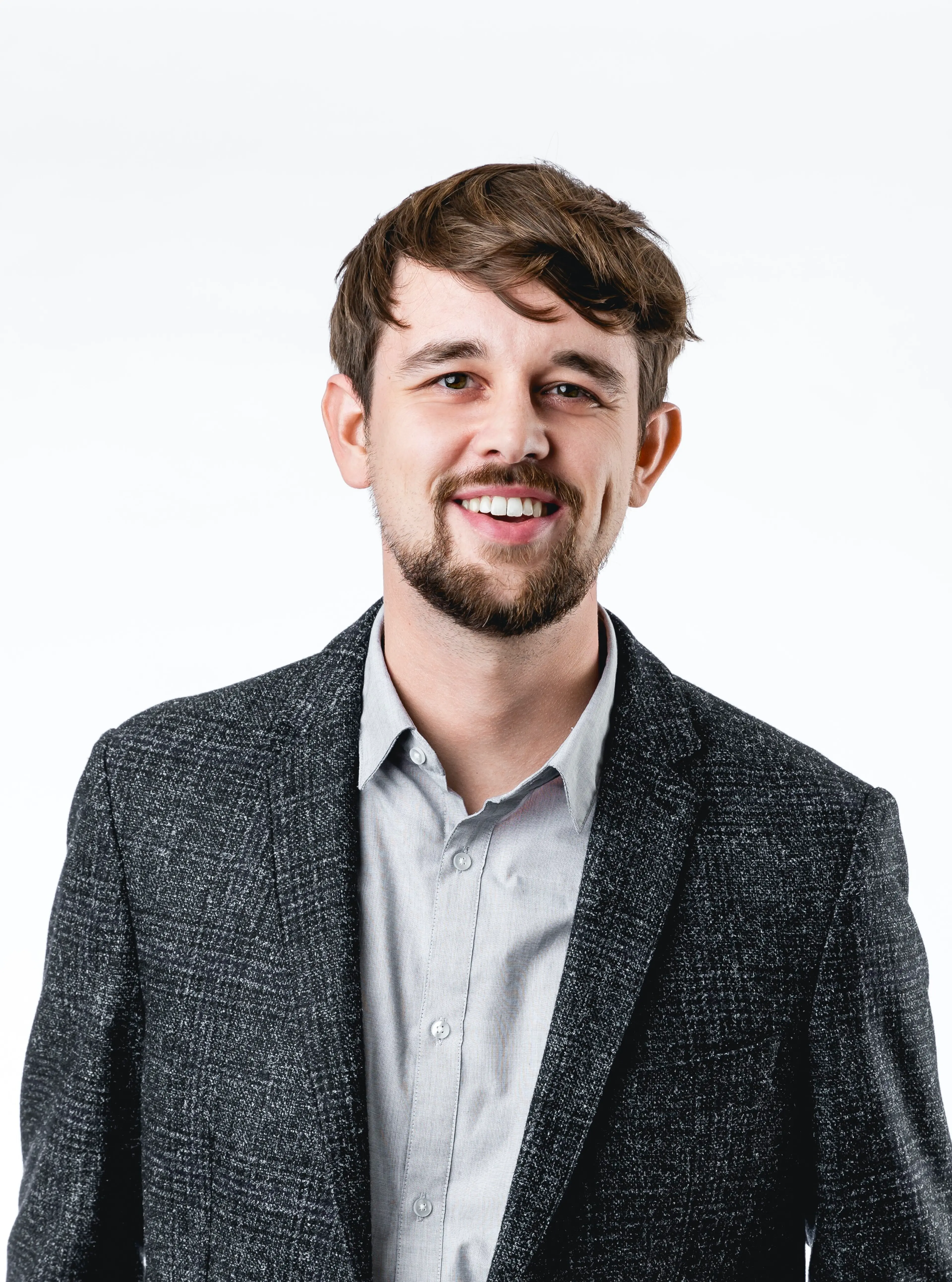 man with beard wearing a grey jacket