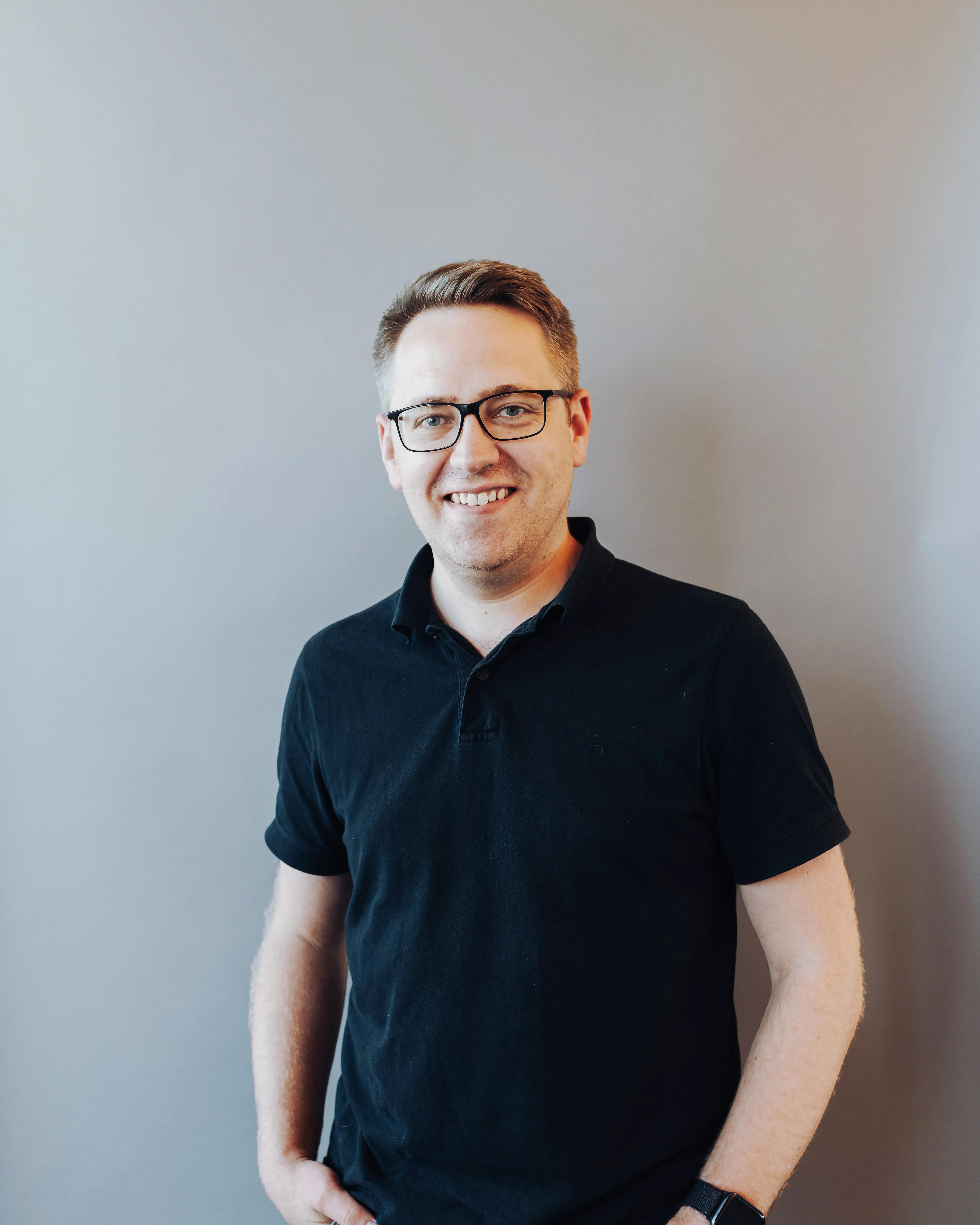 Smiling man with glasses.