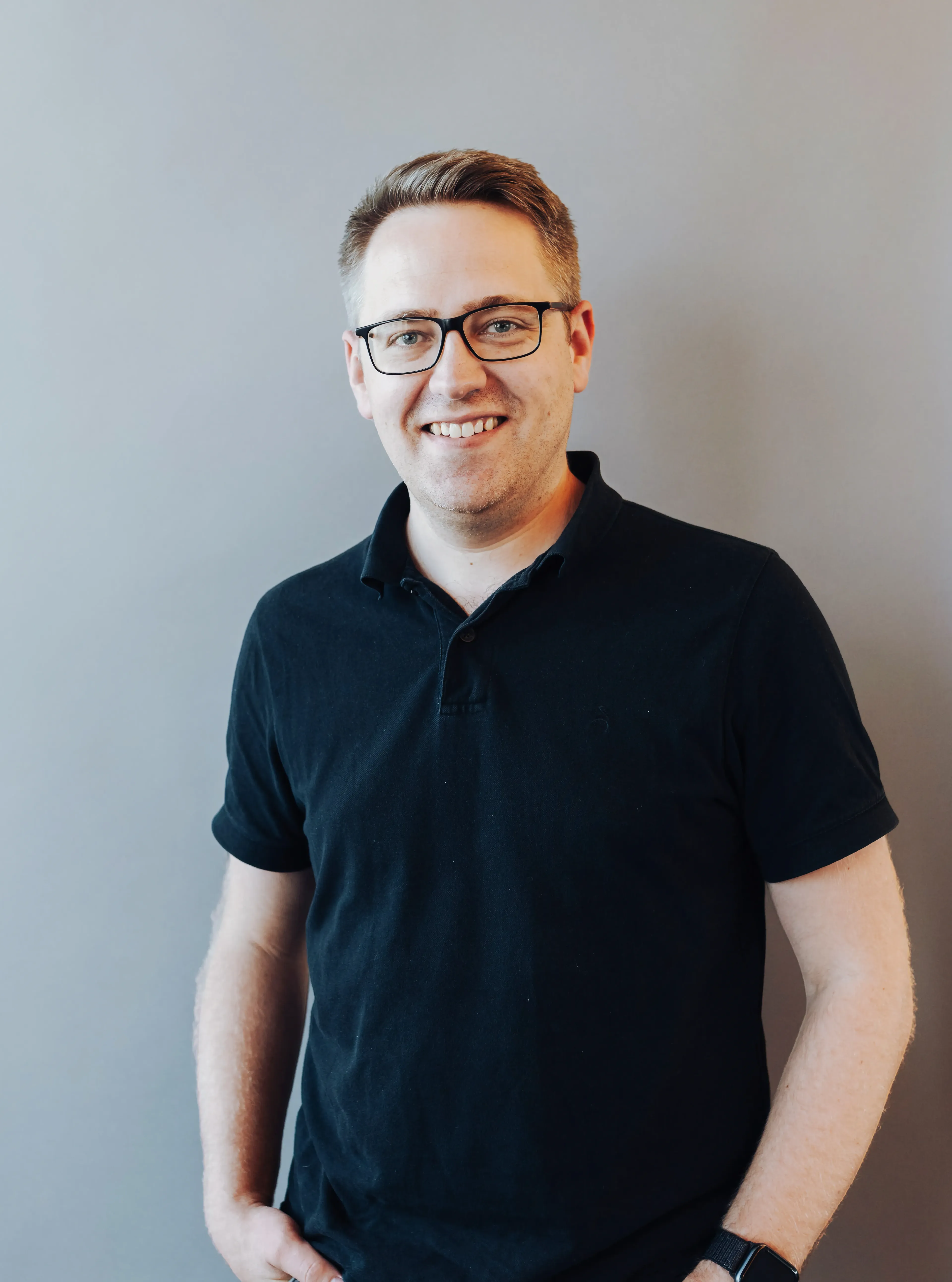 Smiling man with glasses.