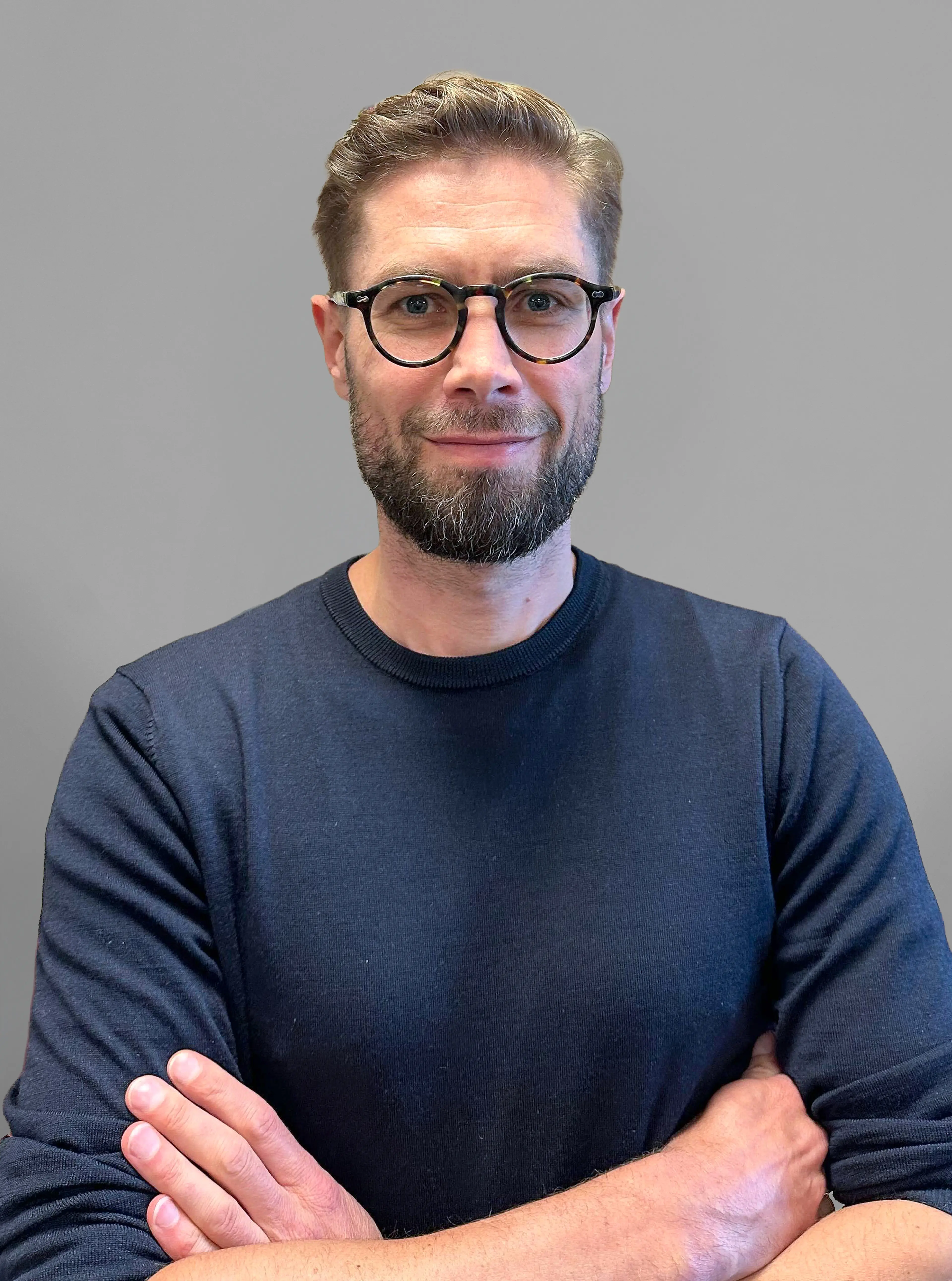 Man with glasses wearing black shirt