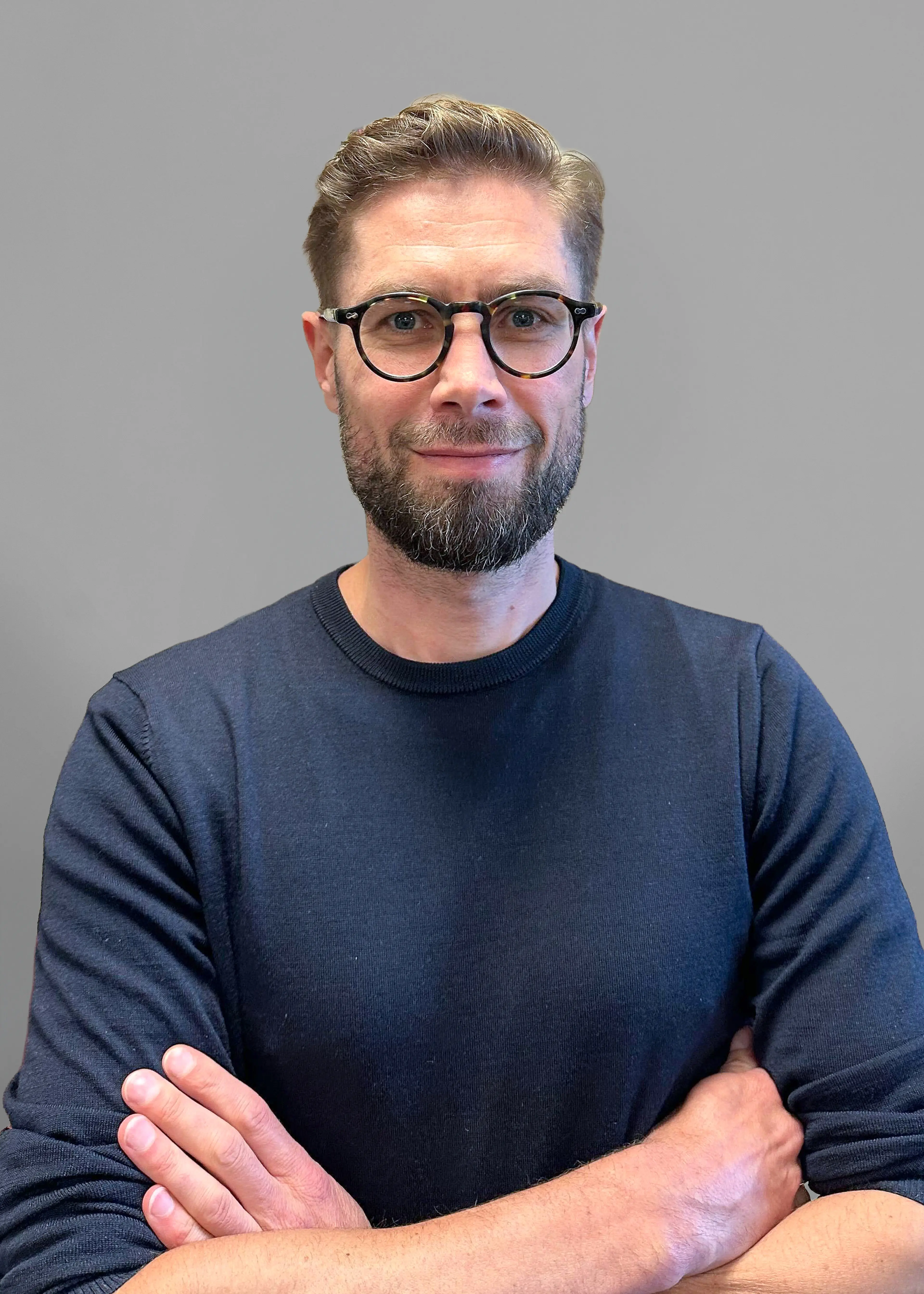 Man with glasses wearing black shirt